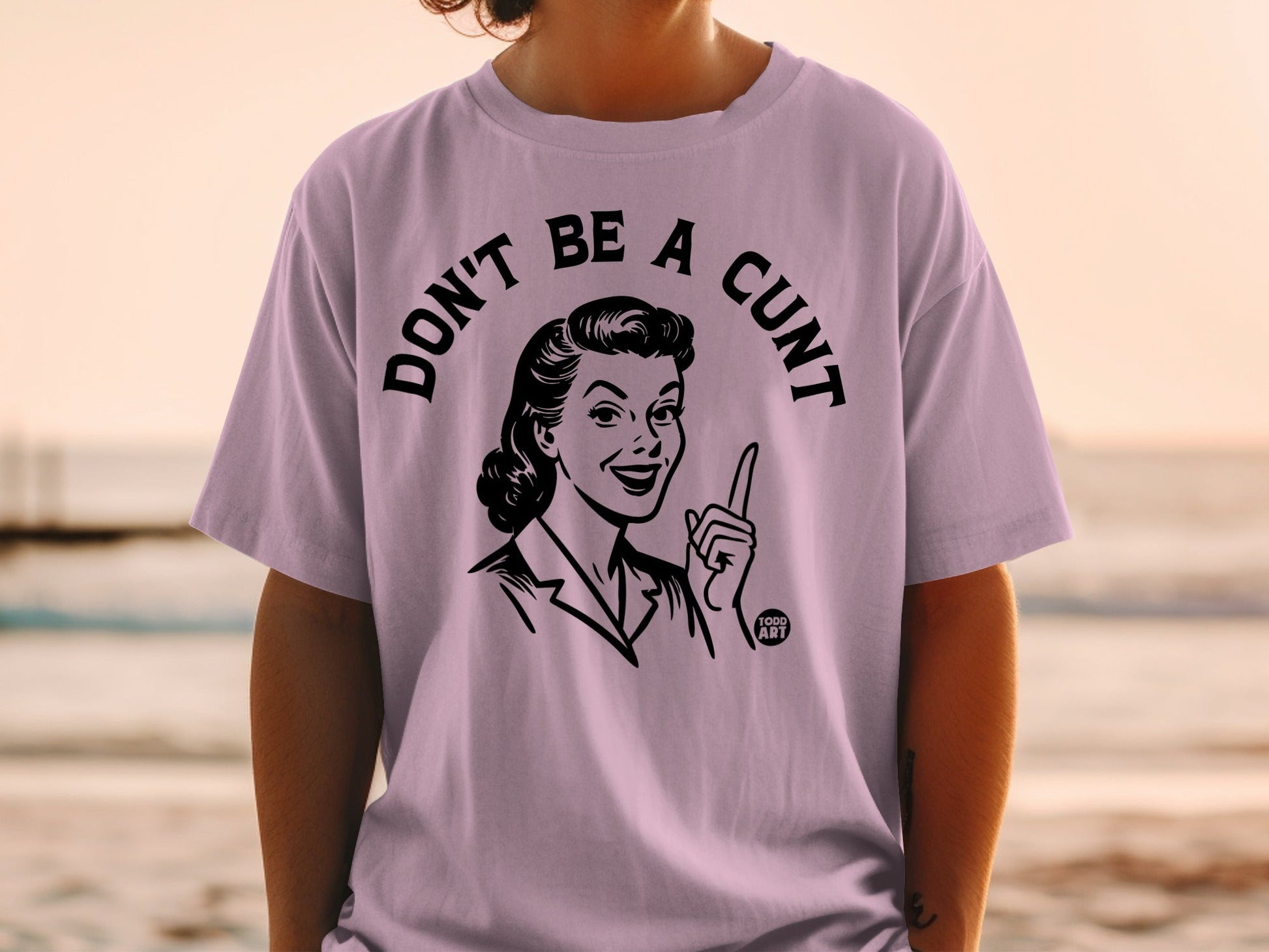 T-shirt with black and white line drawing of a woman saying "DON'T BE A CUNT".