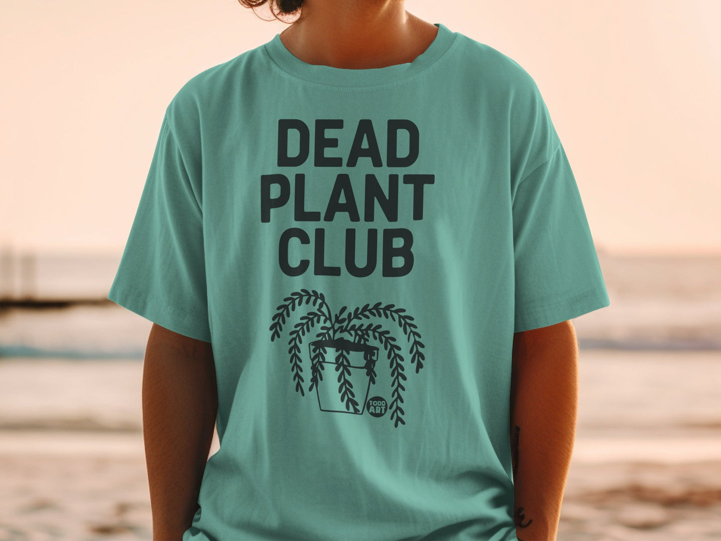 Teal t-shirt with "DEAD PLANT CLUB" and hanging plant graphic.