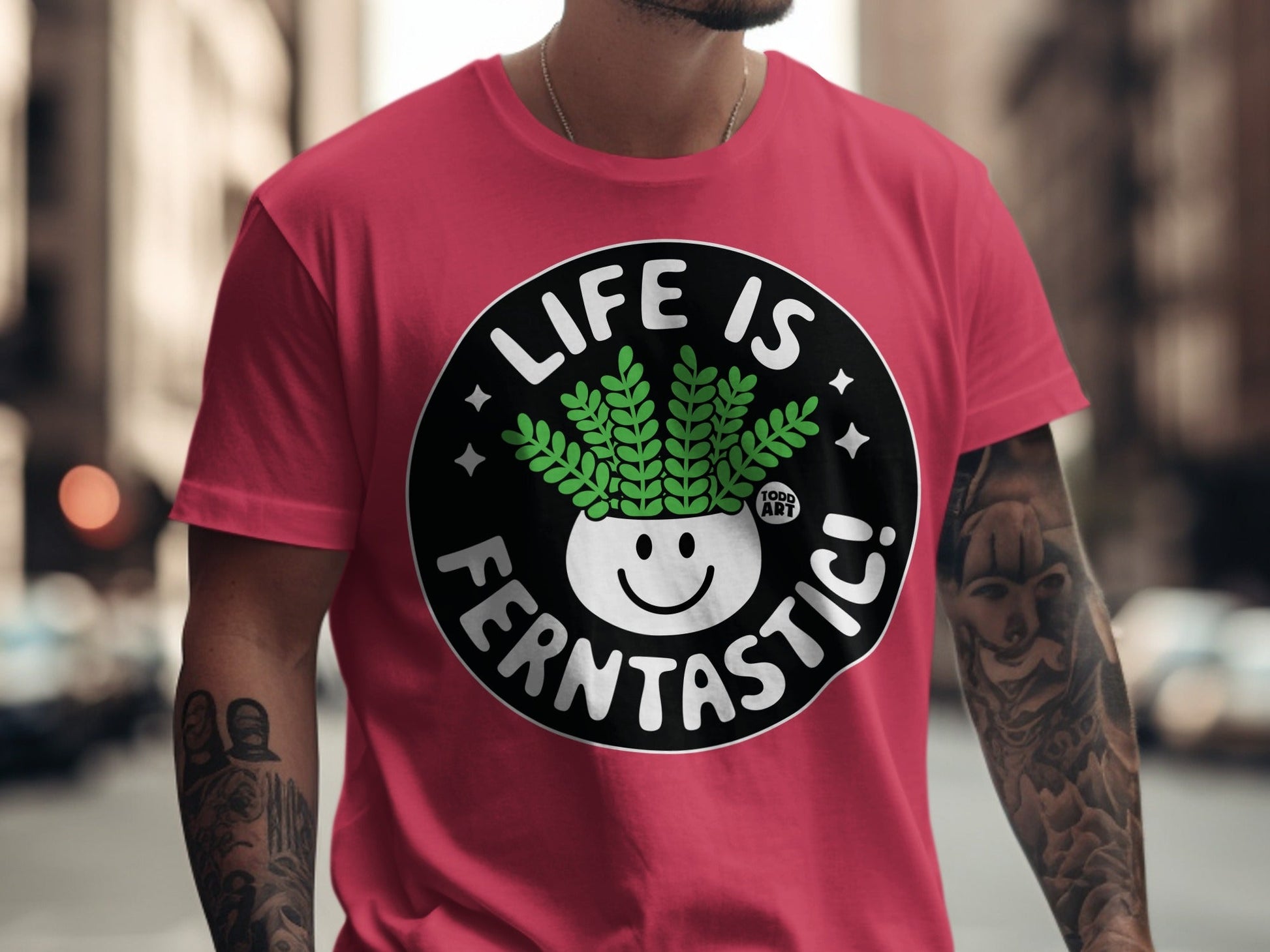 Red t-shirt with "Life is Fern-tastic!" slogan and cartoon fern in pot.