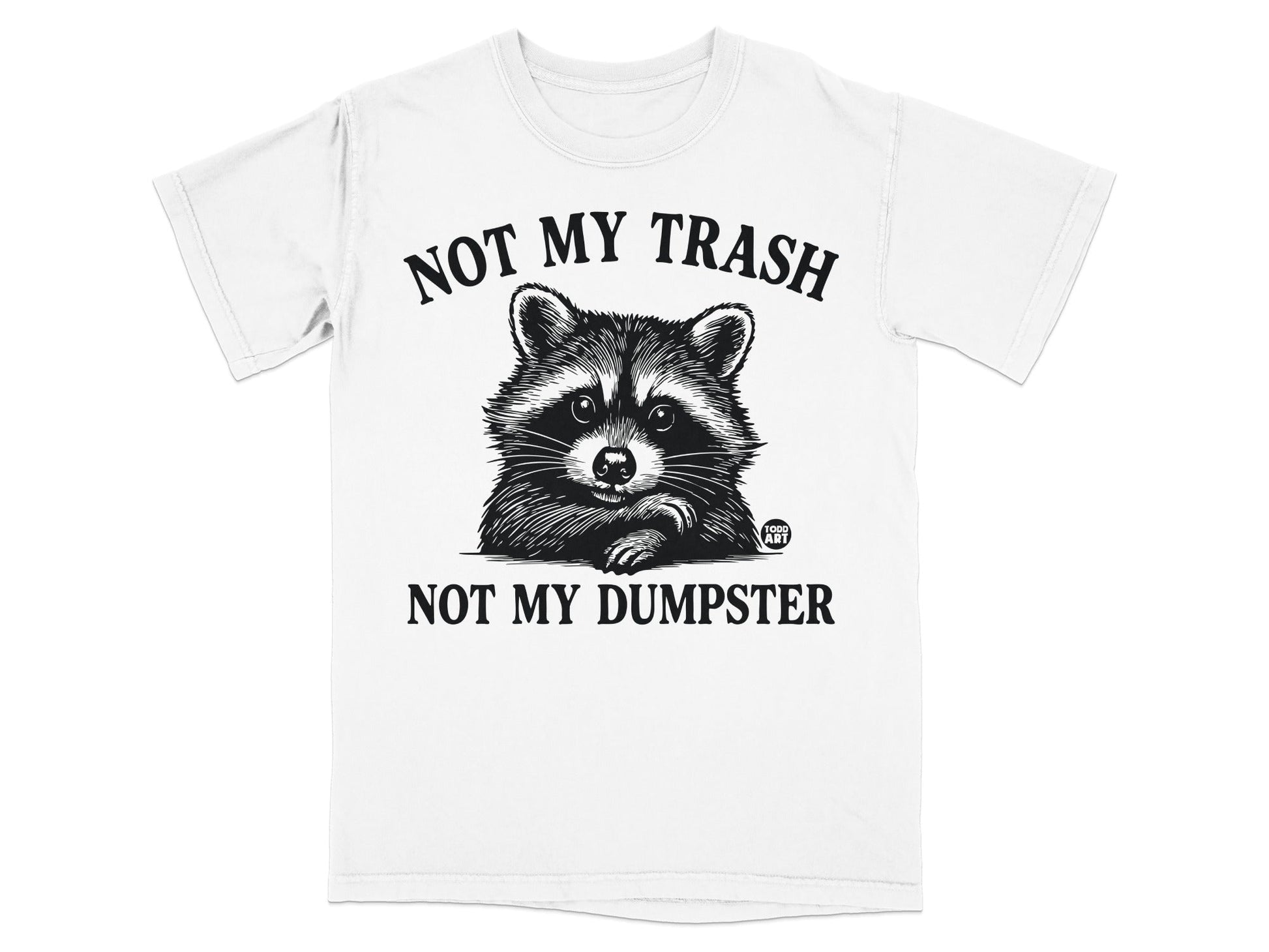 White t-shirt with a raccoon illustration and text "NOT MY TRASH NOT MY DUMPSTER".