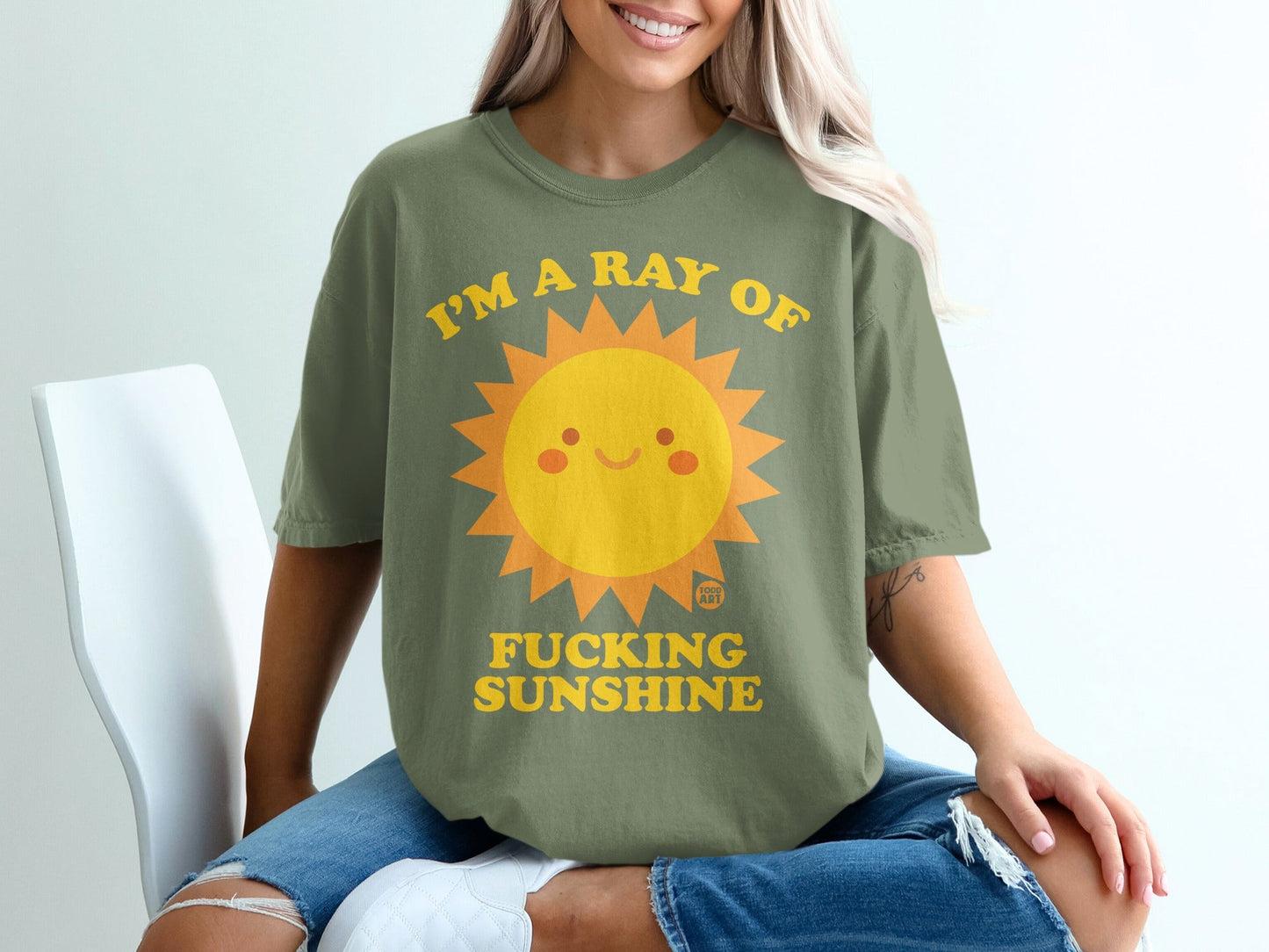 Green t-shirt with a smiling sun graphic and "I'M A RAY OF FUCKING SUNSHINE" text.