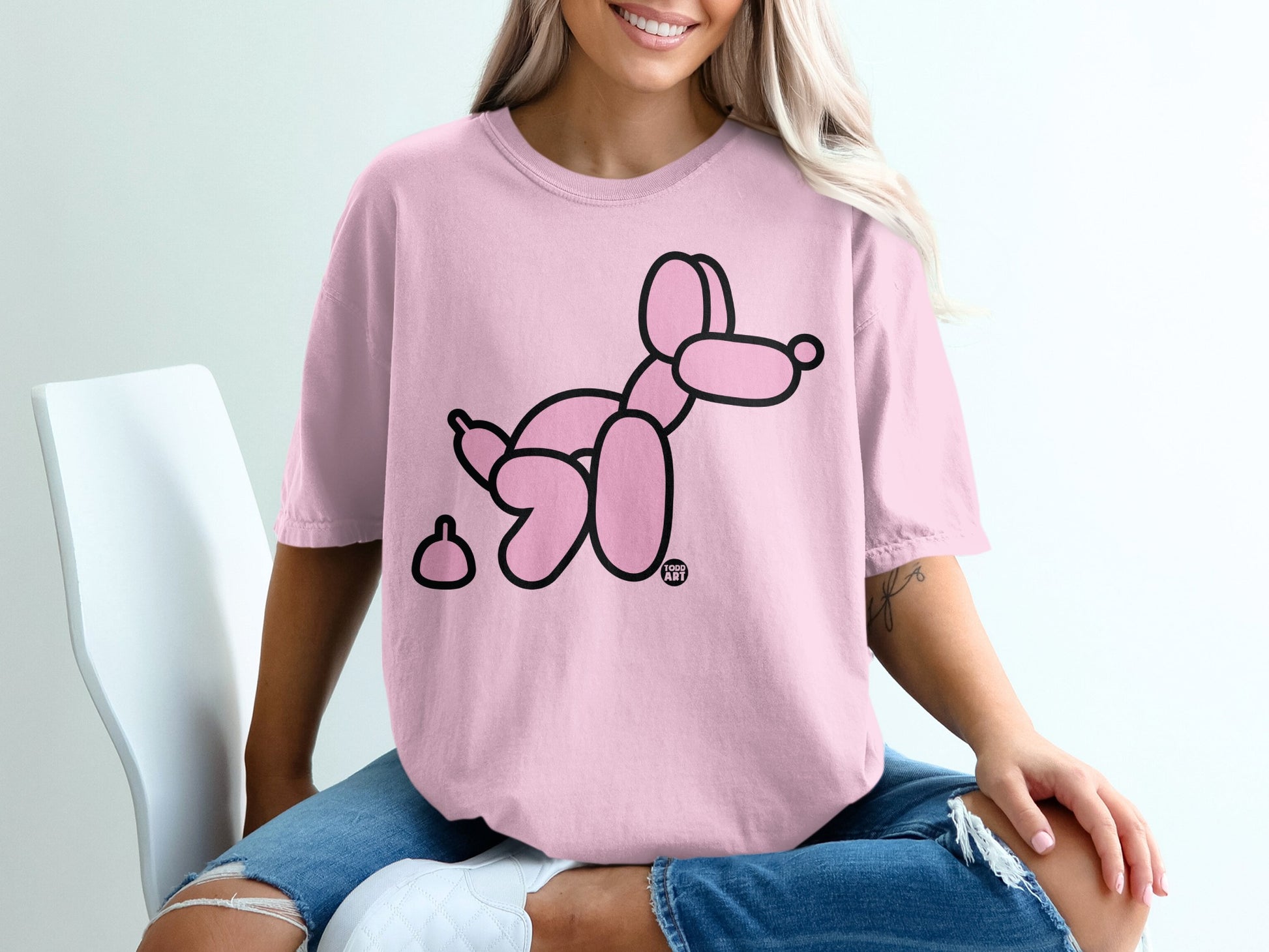 Pink t-shirt with black balloon dog and poop design.