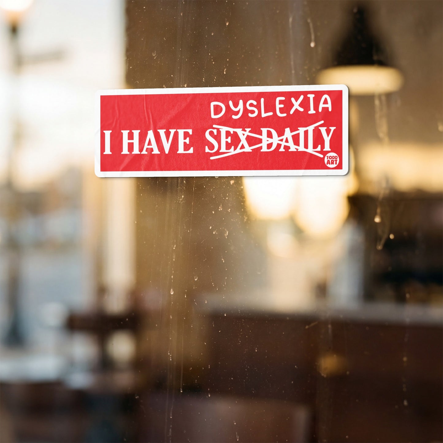 Red sticker with white text that reads "I HAVE SEX DAILY" with "SEX" crossed out and "DYSLEXIA" above.