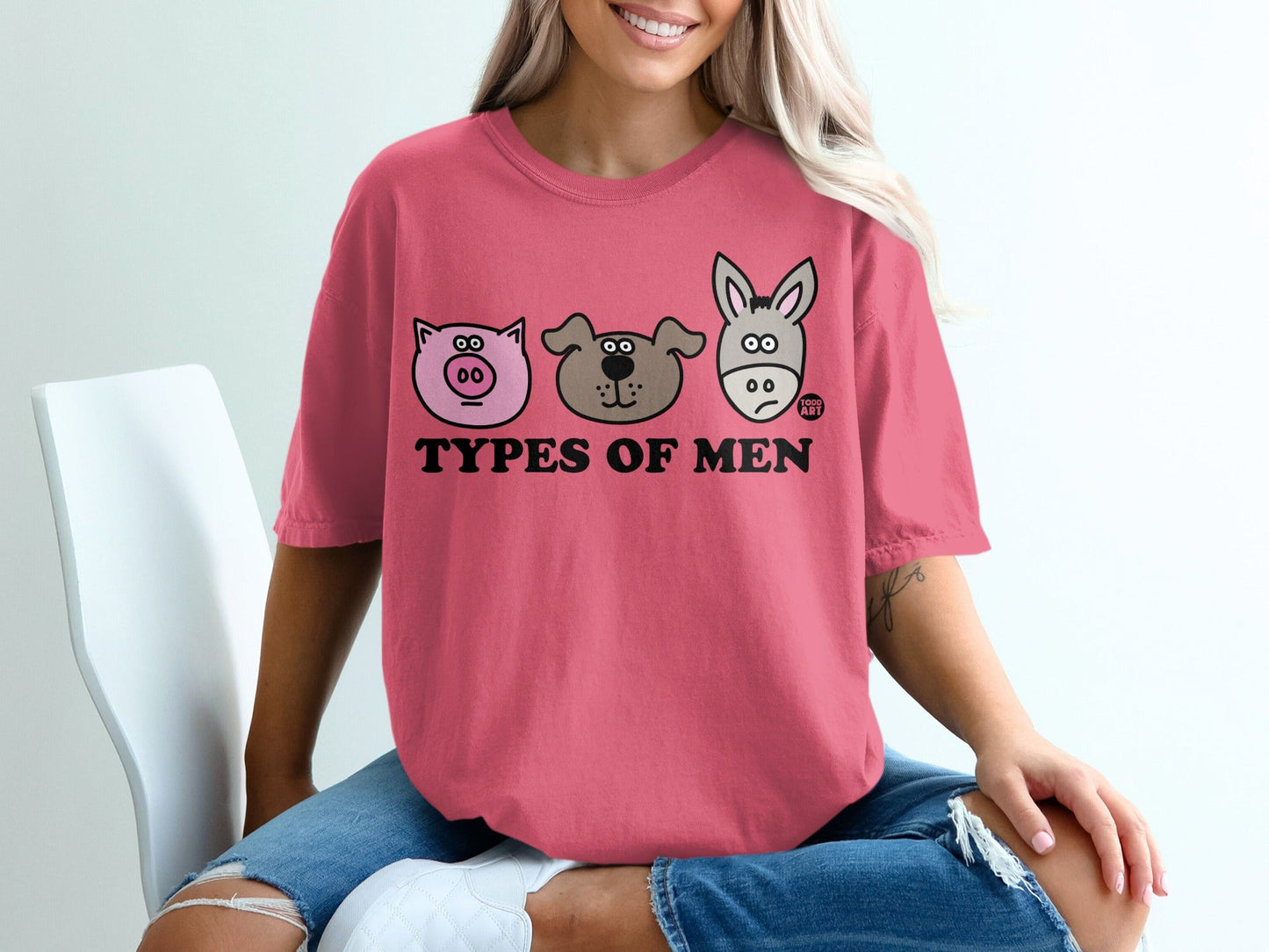 Pink t-shirt with "Types of Men" text and cartoon animal faces: pig, dog, and donkey.