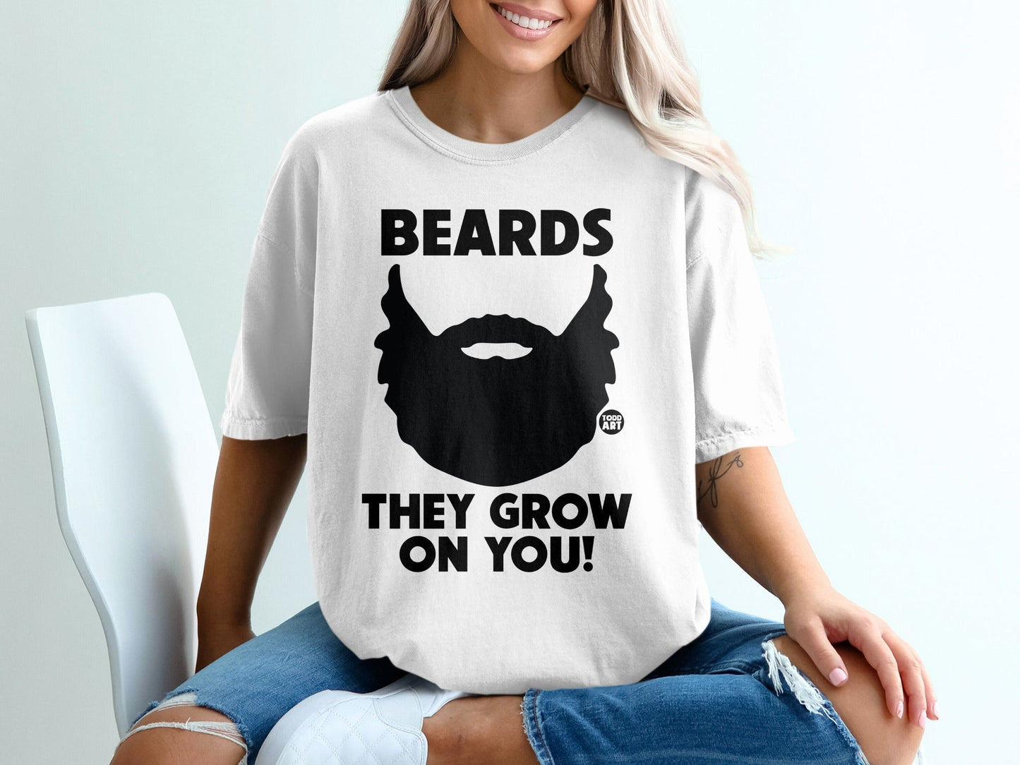 White t-shirt with black beard graphic and text "BEARDS THEY GROW ON YOU!".