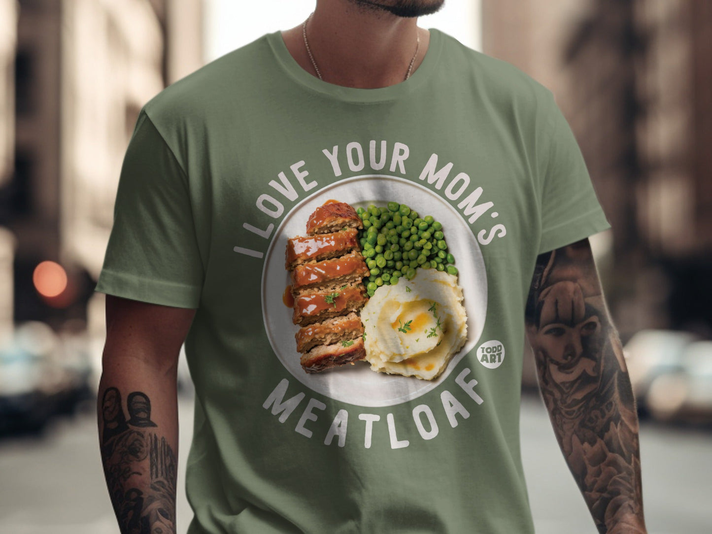 Green t-shirt featuring "I Love Your Mom's Meatloaf" graphic with meatloaf and peas.