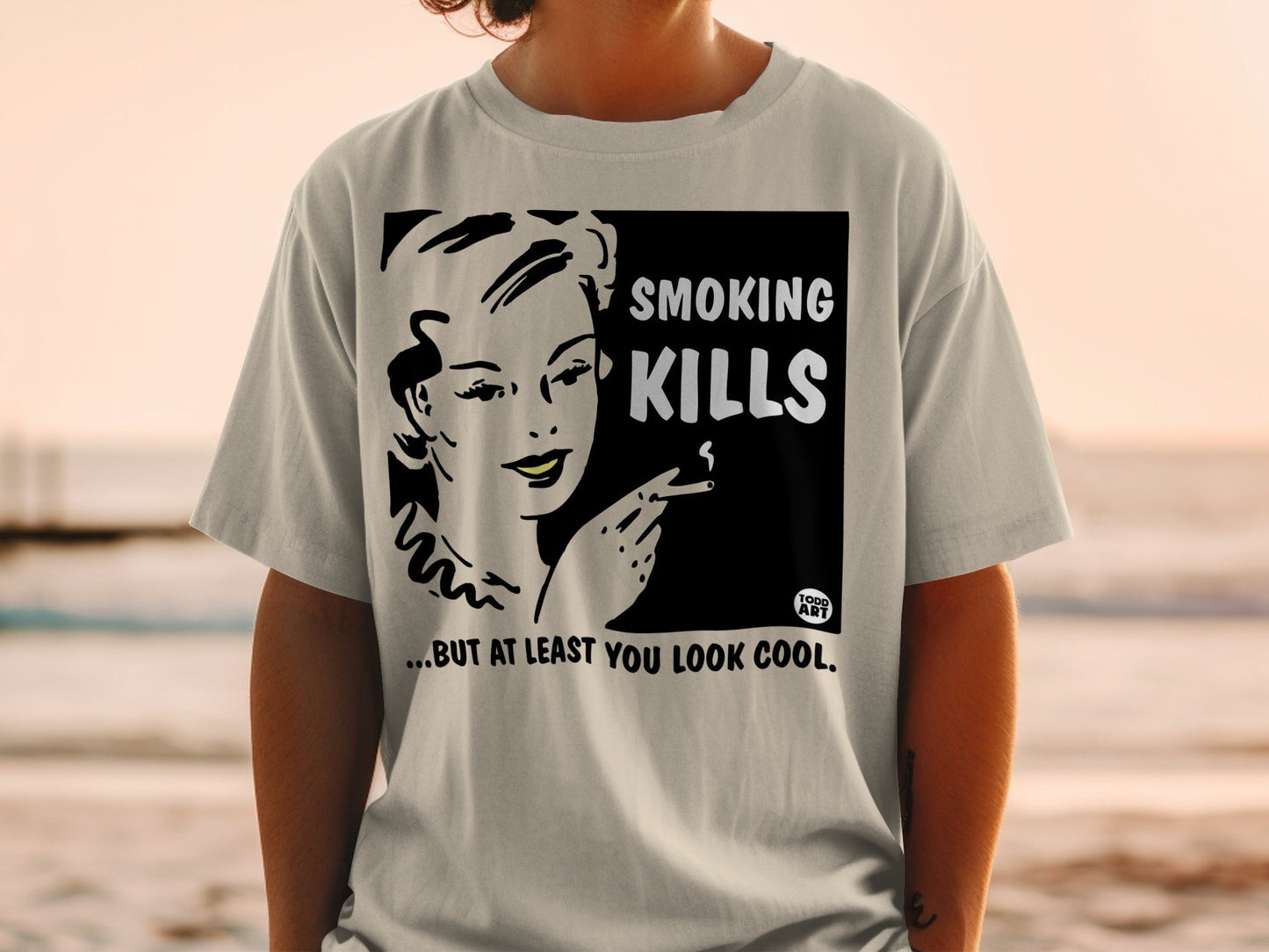 T-shirt with retro graphic: woman smoking, text "SMOKING KILLS... BUT AT LEAST YOU LOOK COOL."