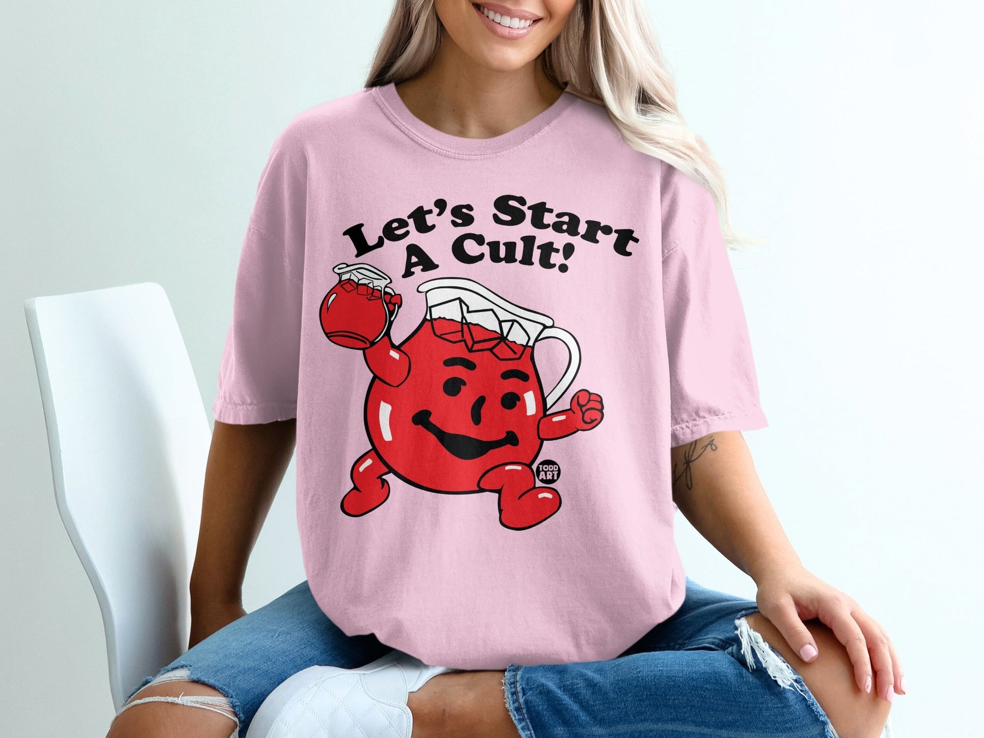 Kool-Aid Man character on pink t-shirt with text "Let's Start A Cult!".