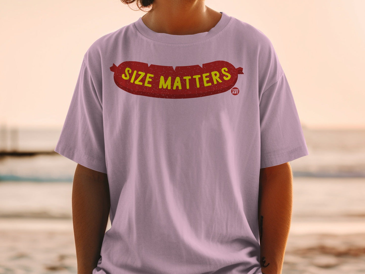 Lilac t-shirt with "SIZE MATTERS" text and a sausage graphic.