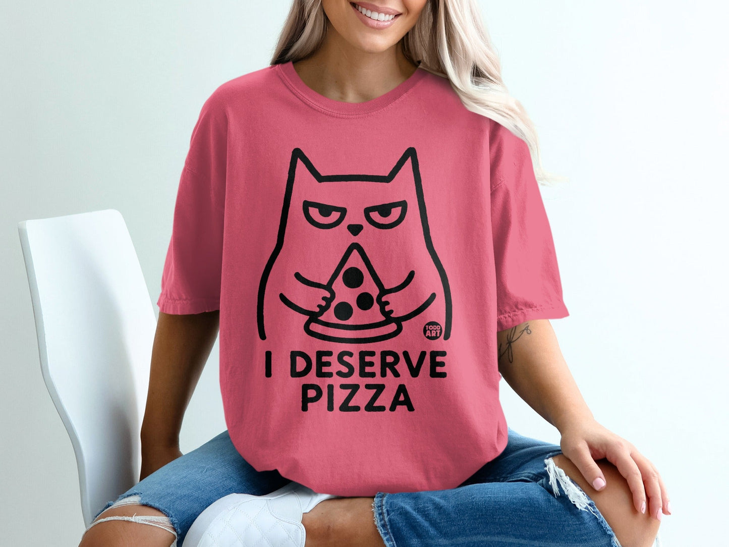 Pink t-shirt with black cat holding pizza and text "I DESERVE PIZZA".