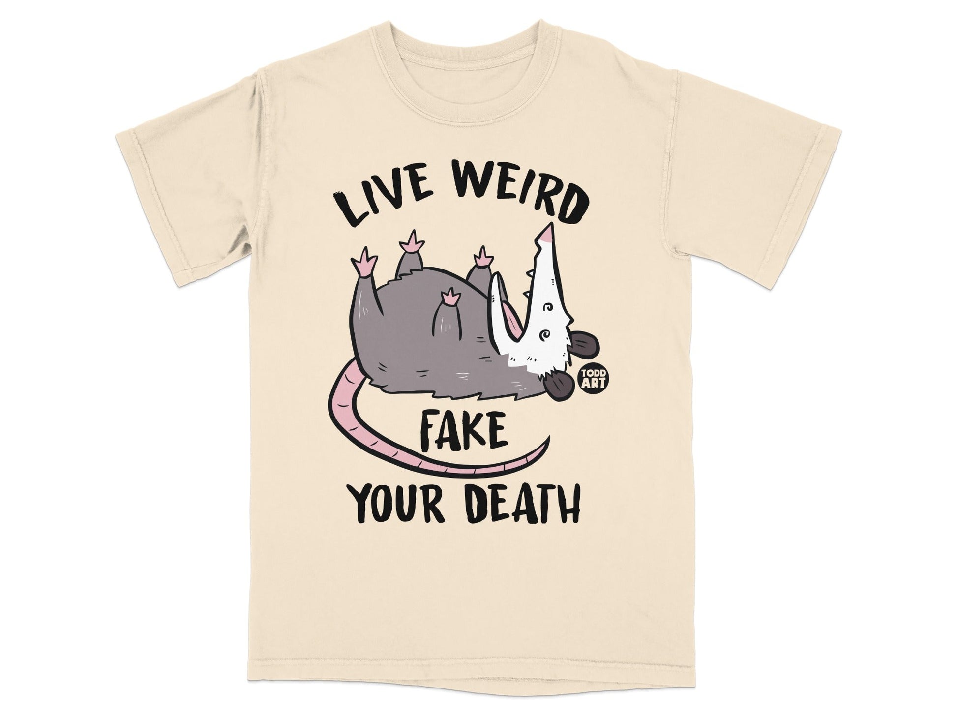 Cream t-shirt with opossum playing dead and text "LIVE WEIRD FAKE YOUR DEATH".