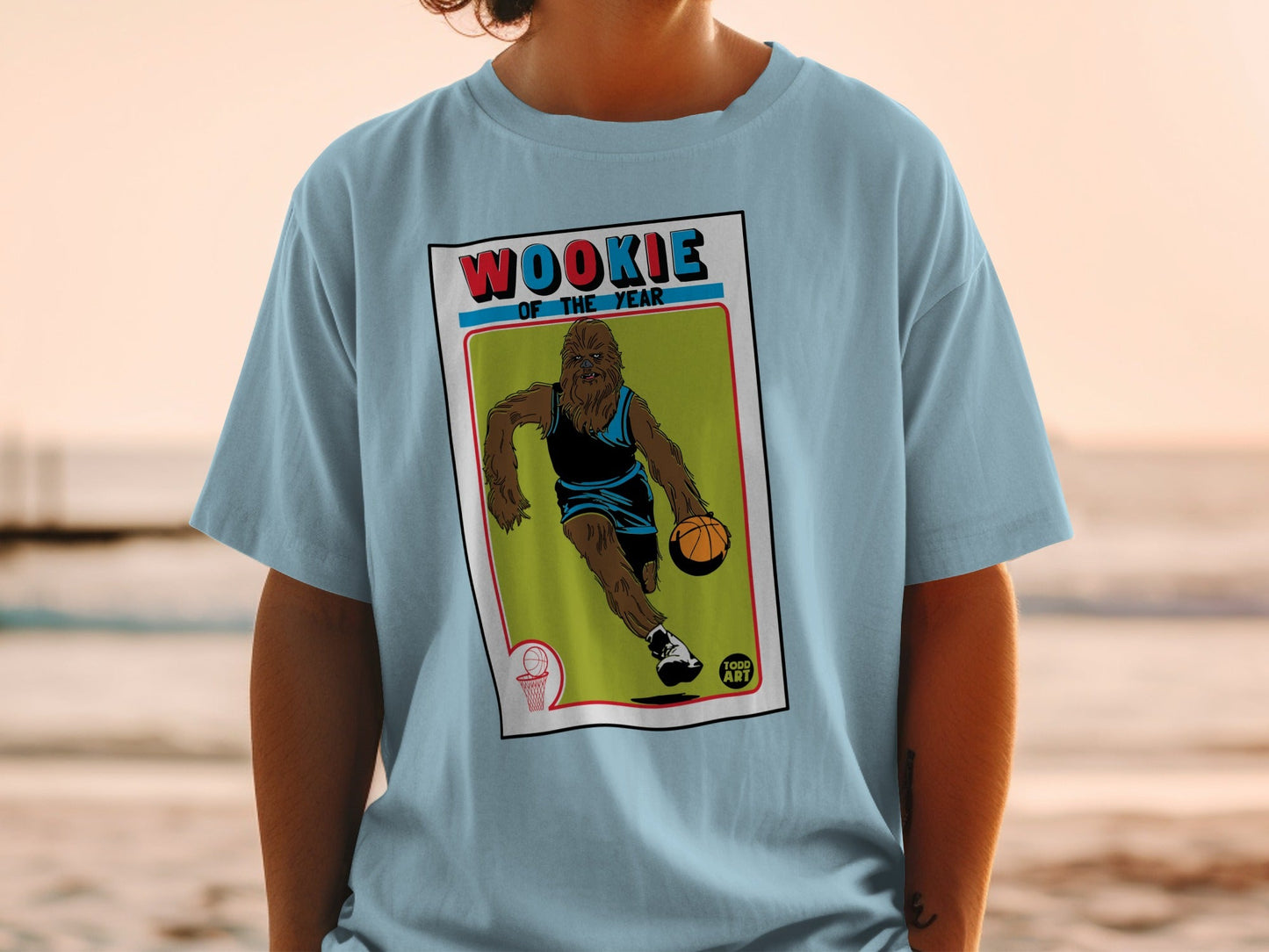 Light blue t-shirt with Chewbacca dribbling a basketball on a vintage card.