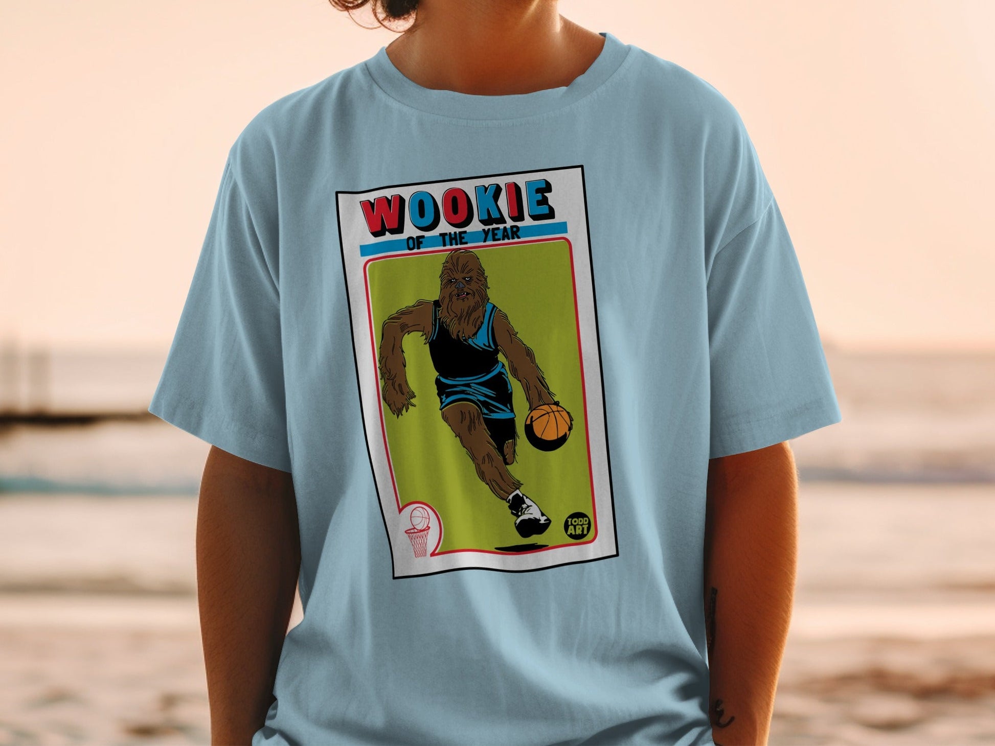 Light blue t-shirt with Chewbacca dribbling a basketball on a vintage card.