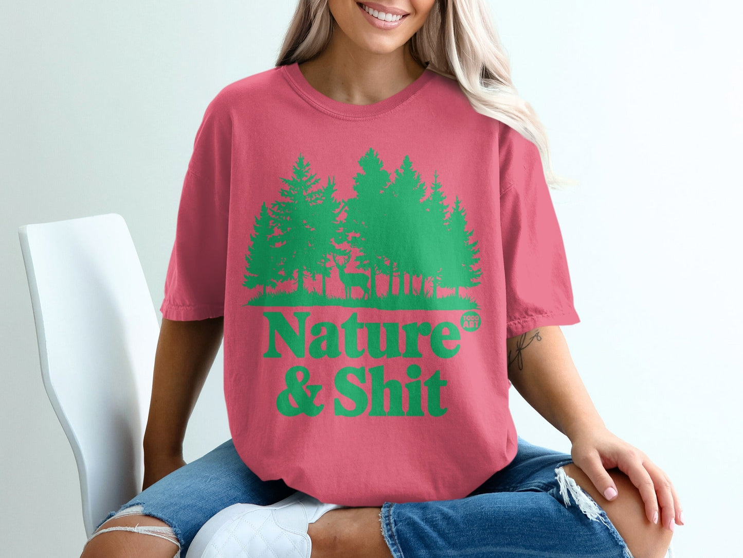 Pink t-shirt with green trees and "Nature & Shit" text.
