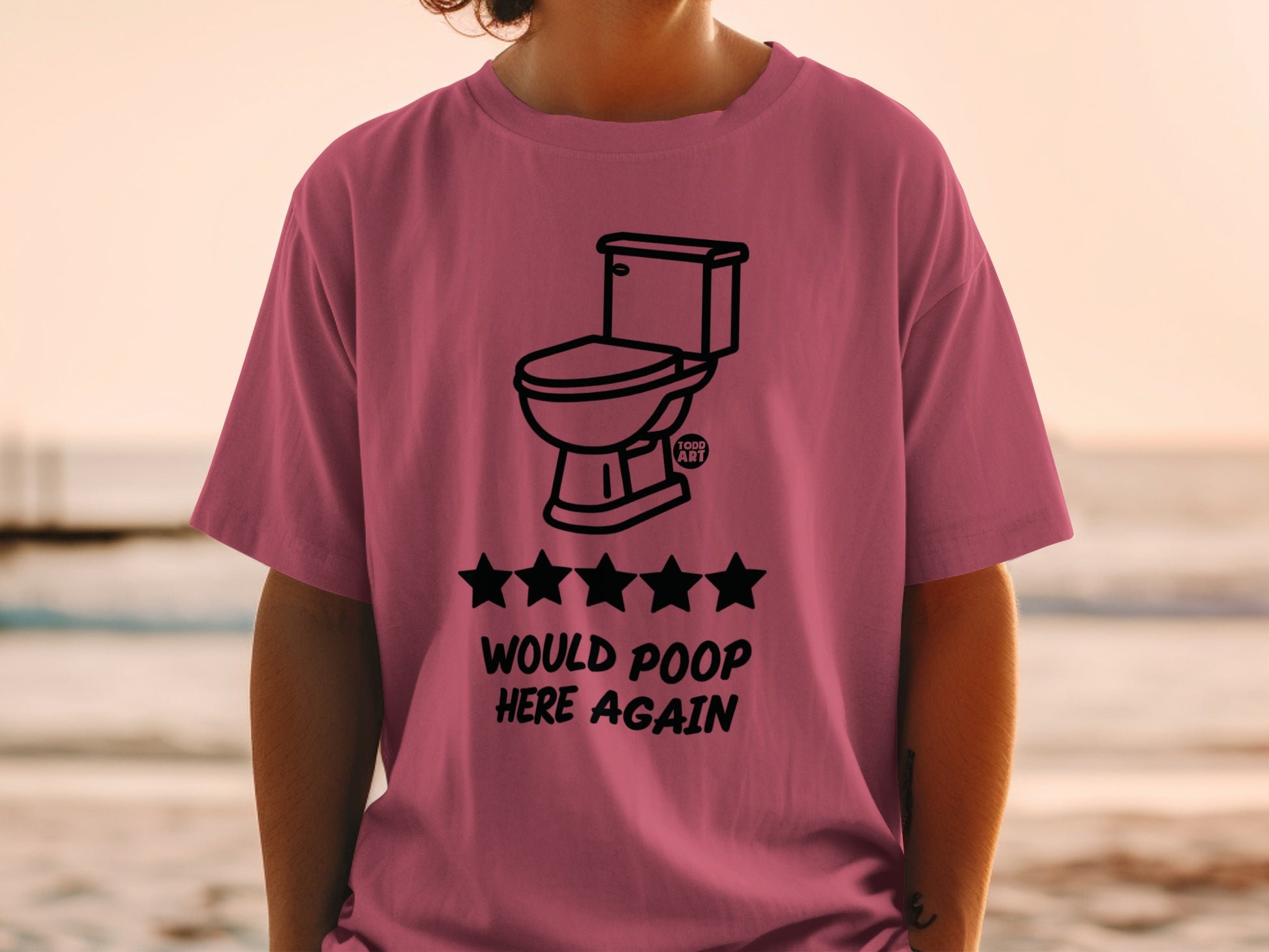 Pink t-shirt with toilet and five stars, "Would poop here again" text.