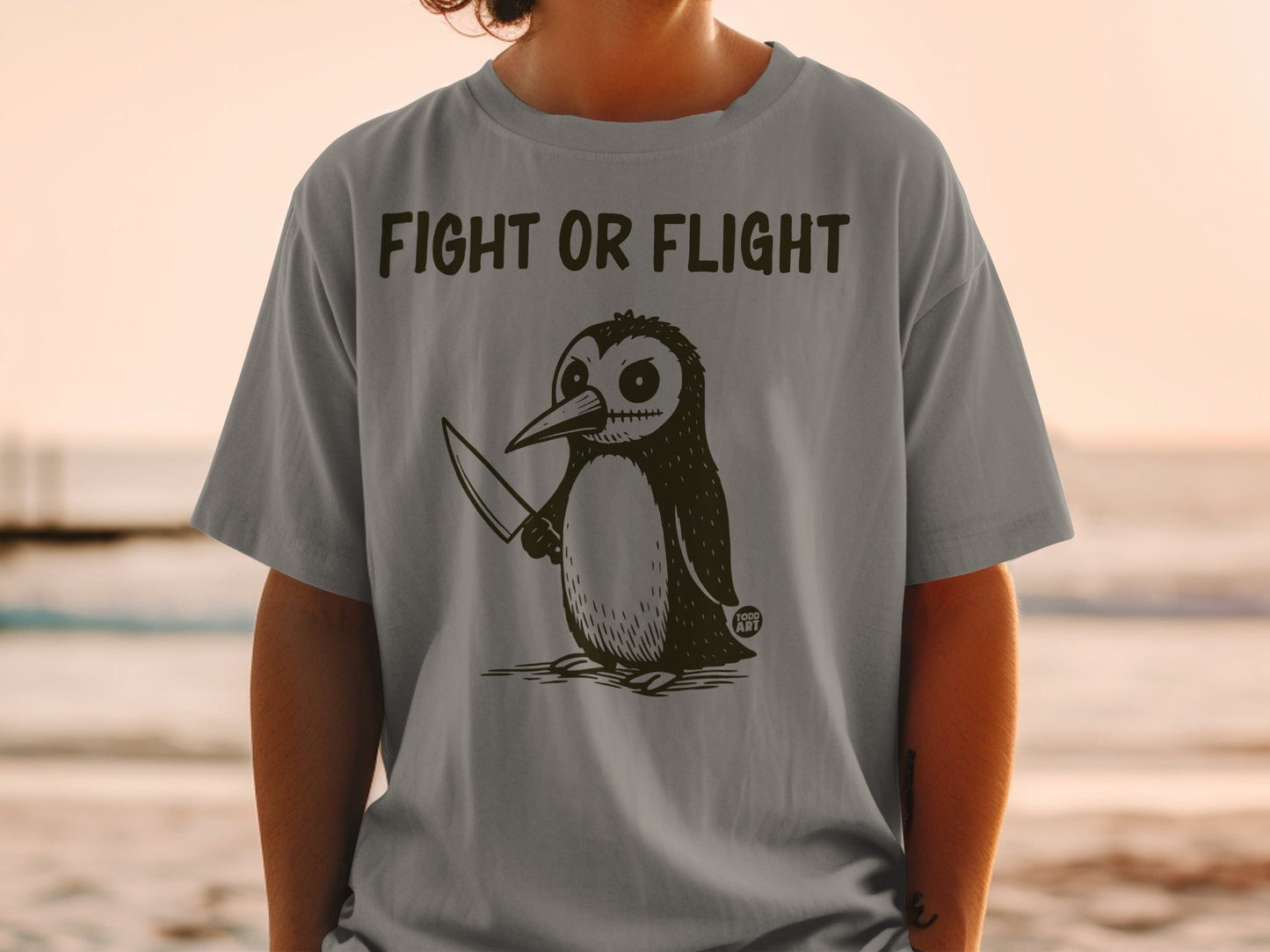Penguin with a knife and the text "FIGHT OR FLIGHT" on a t-shirt.