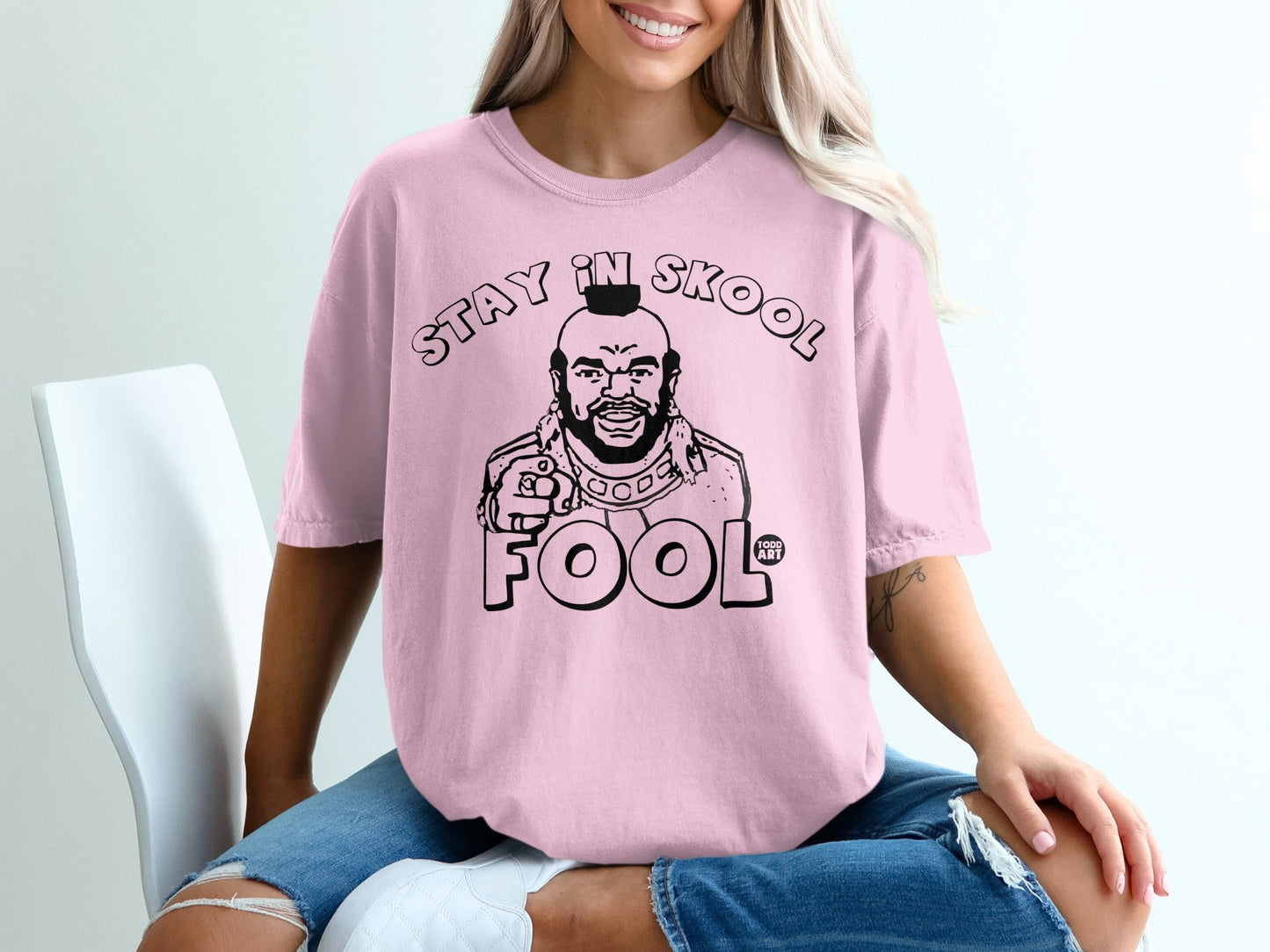 Pink t-shirt with black graphic of Mr. T saying "Stay in Skool Fool".