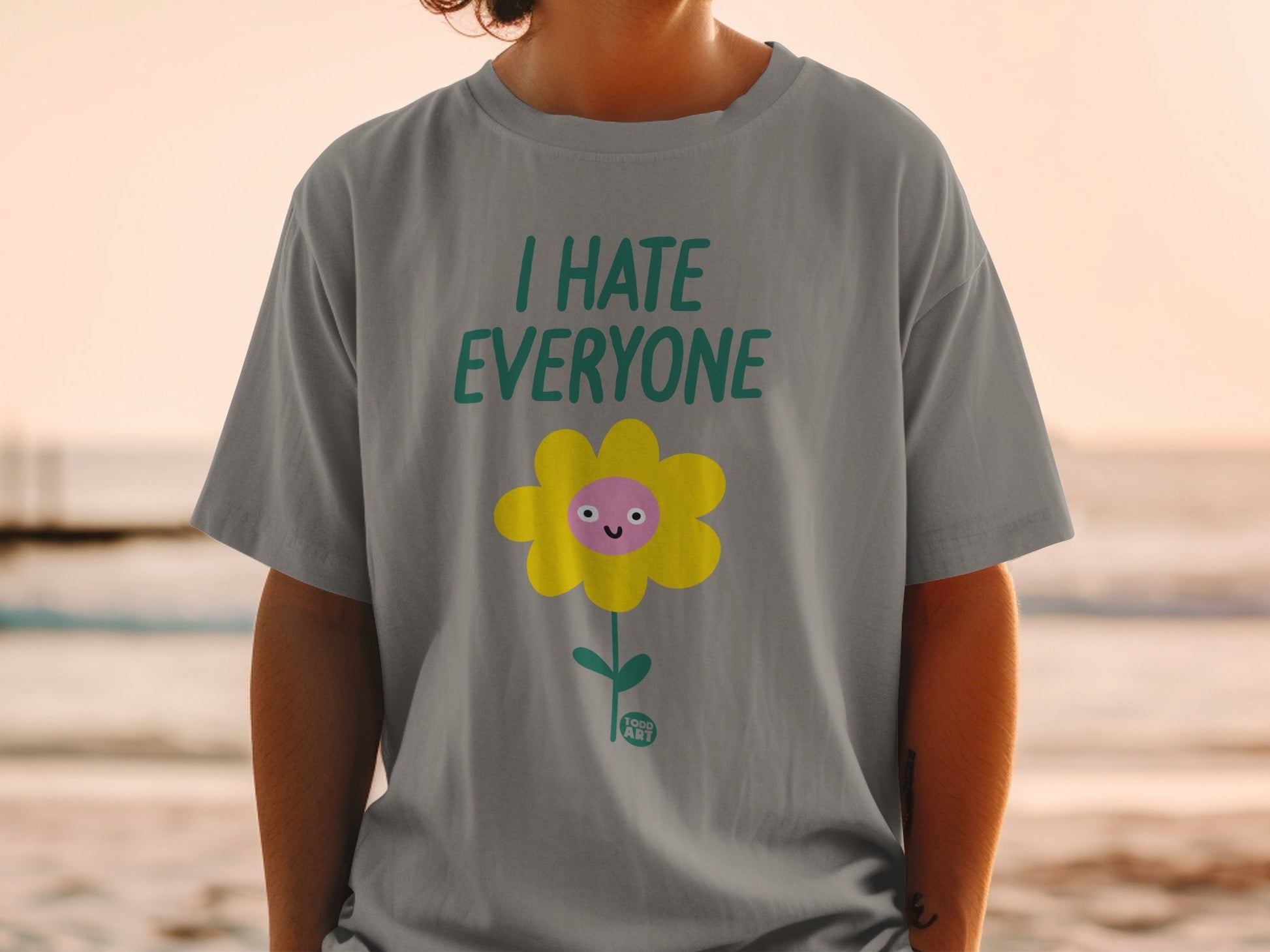Grey t-shirt with yellow flower and "I HATE EVERYONE" text.