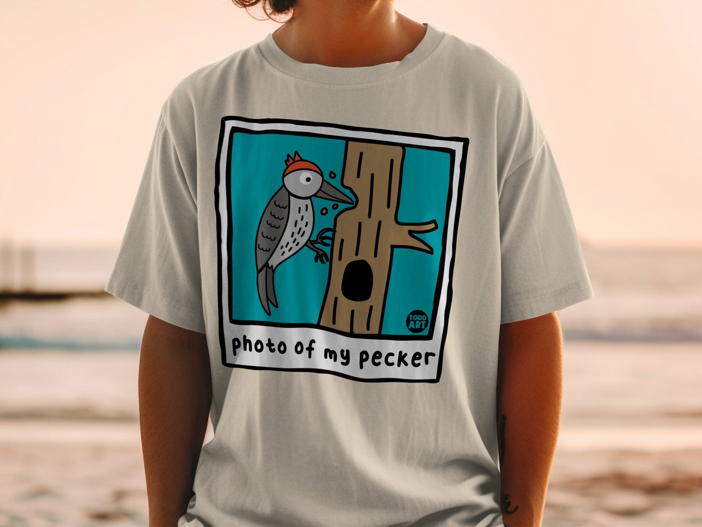 Illustration of a cartoon woodpecker on a tree trunk on a t-shirt.