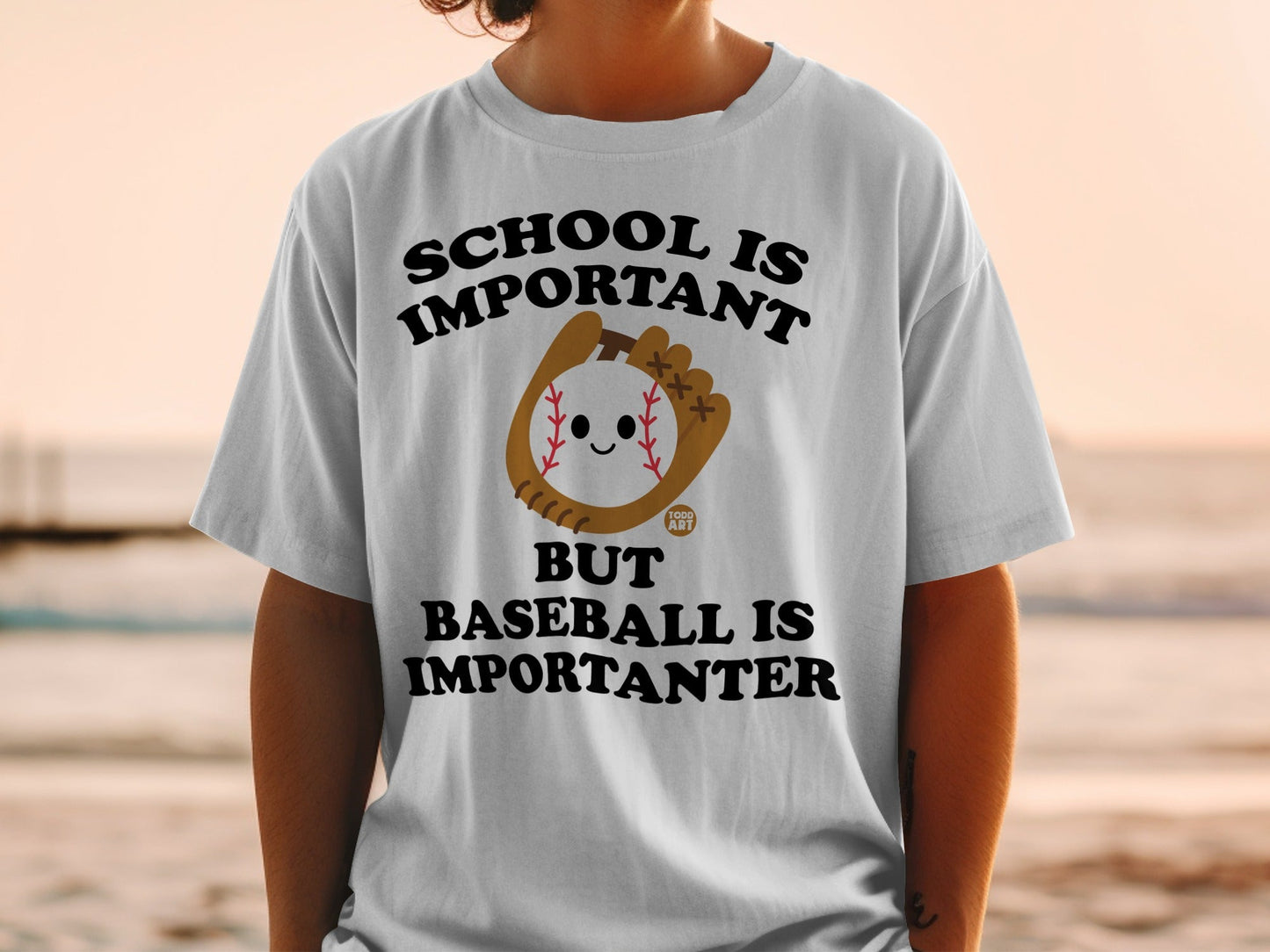 T-shirt with "School is important but baseball is importanter" and baseball graphic.