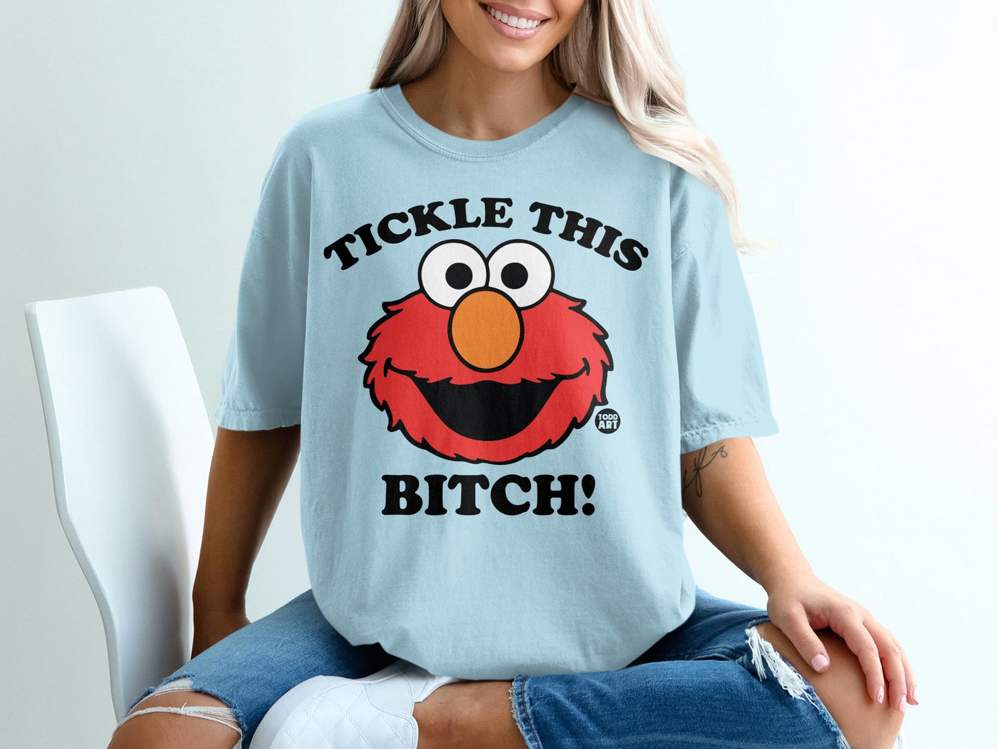 Light blue t-shirt with Elmo face and "Tickle this bitch!" text.
