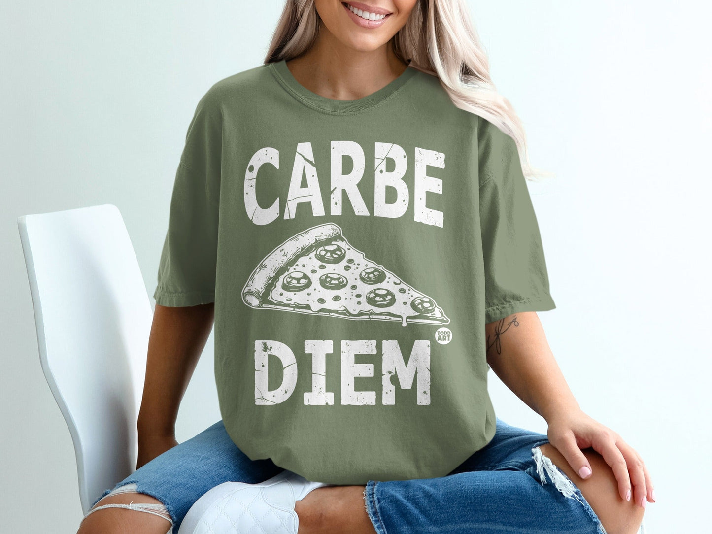 Olive green t-shirt with "CARPE DIEM" text and pizza slice graphic.