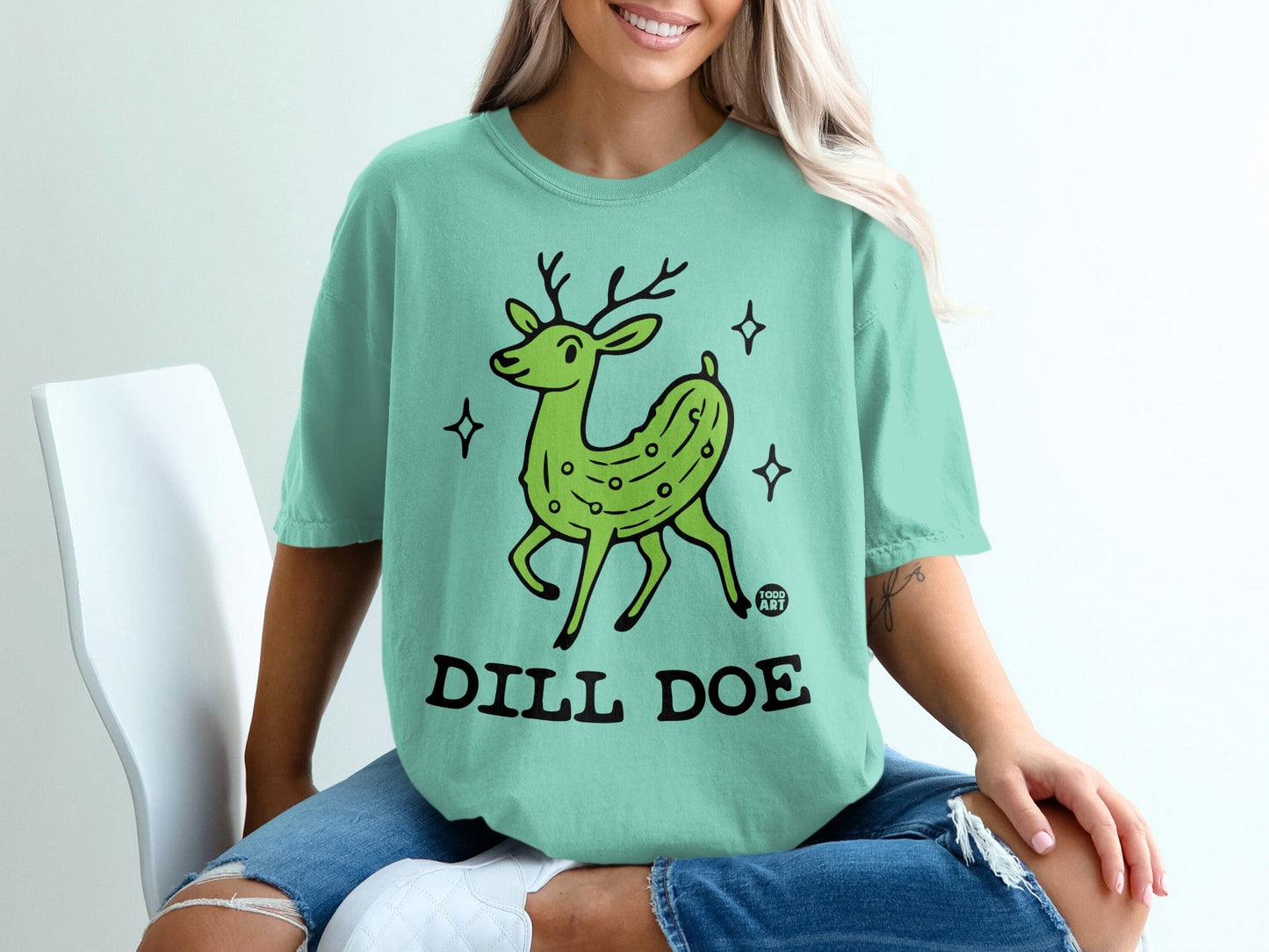 Green cartoon deer with pickle texture, wearing "DILL DOE" text.
