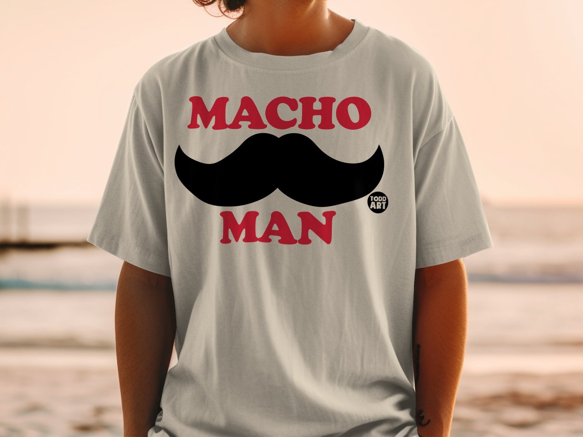 T-shirt with "MACHO MAN" text and a large black mustache graphic.