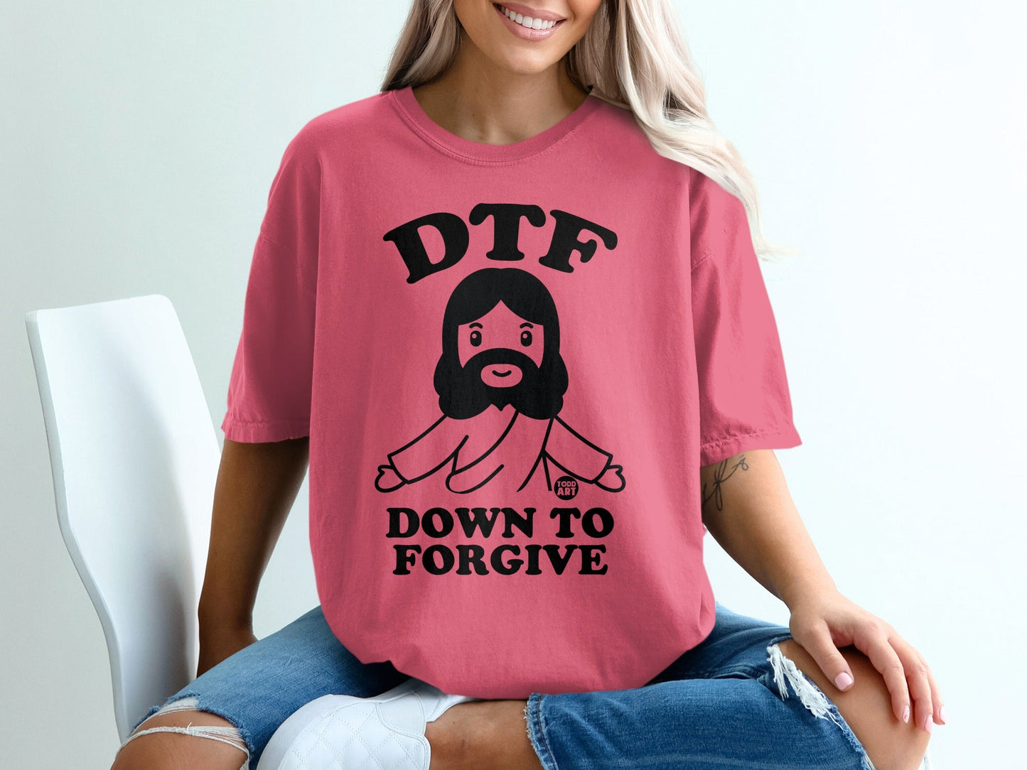 Pink t-shirt with "DTF DOWN TO FORGIVE" and a cartoon Jesus graphic.