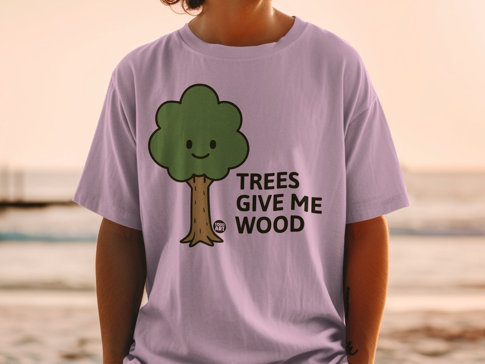 Purple t-shirt with a smiling cartoon tree and the text "TREES GIVE ME WOOD".