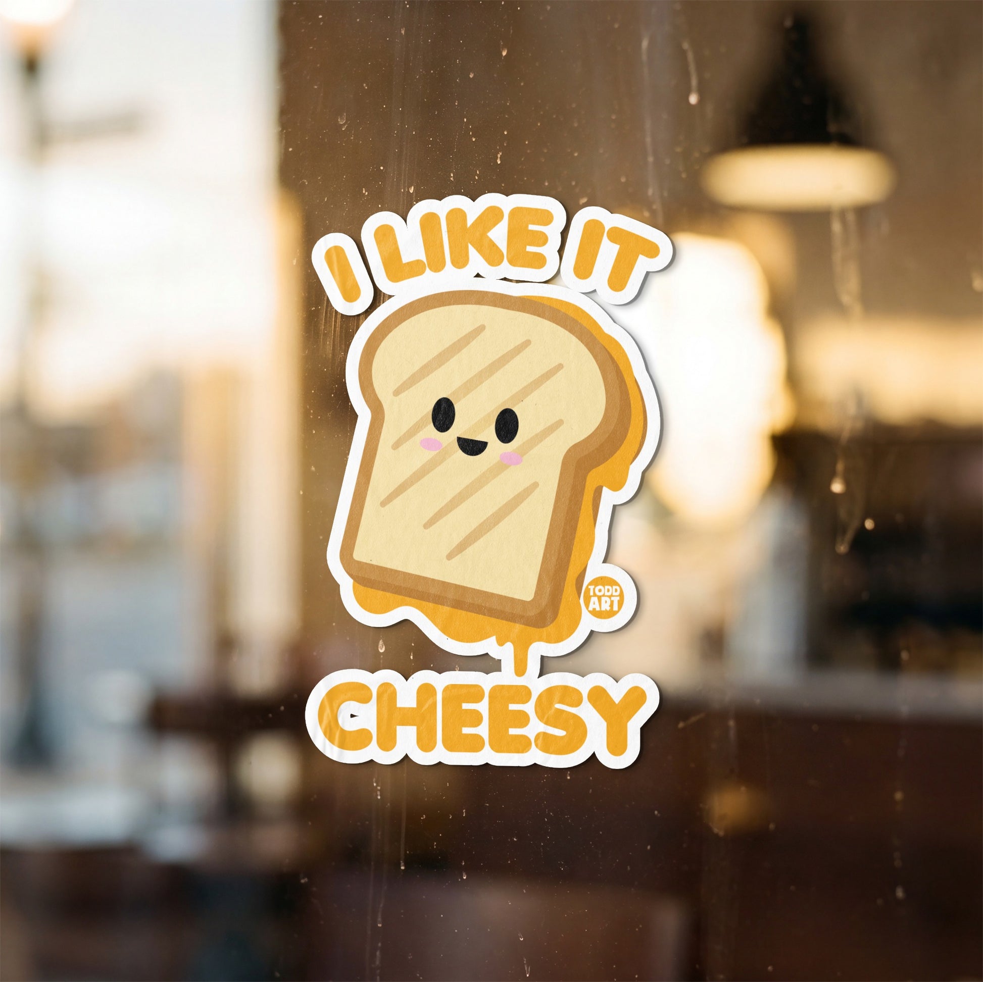 Sticker with cartoon grilled cheese saying "I like it cheesy"