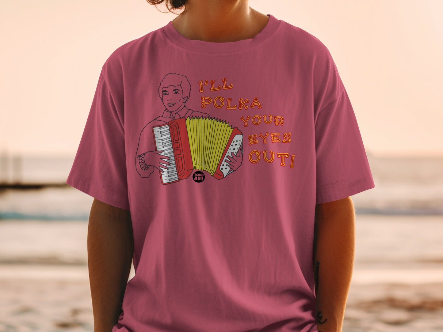 T-shirt with cartoon man playing accordion and text "I'LL POLKA YOUR EYES OUT!"