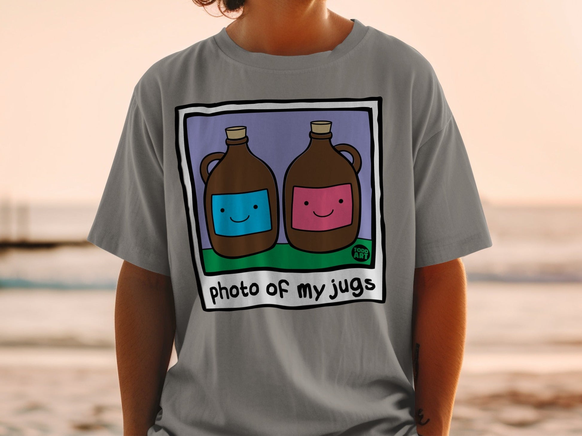 Two jugs, one blue, one pink, with cartoon faces, on a t-shirt.
