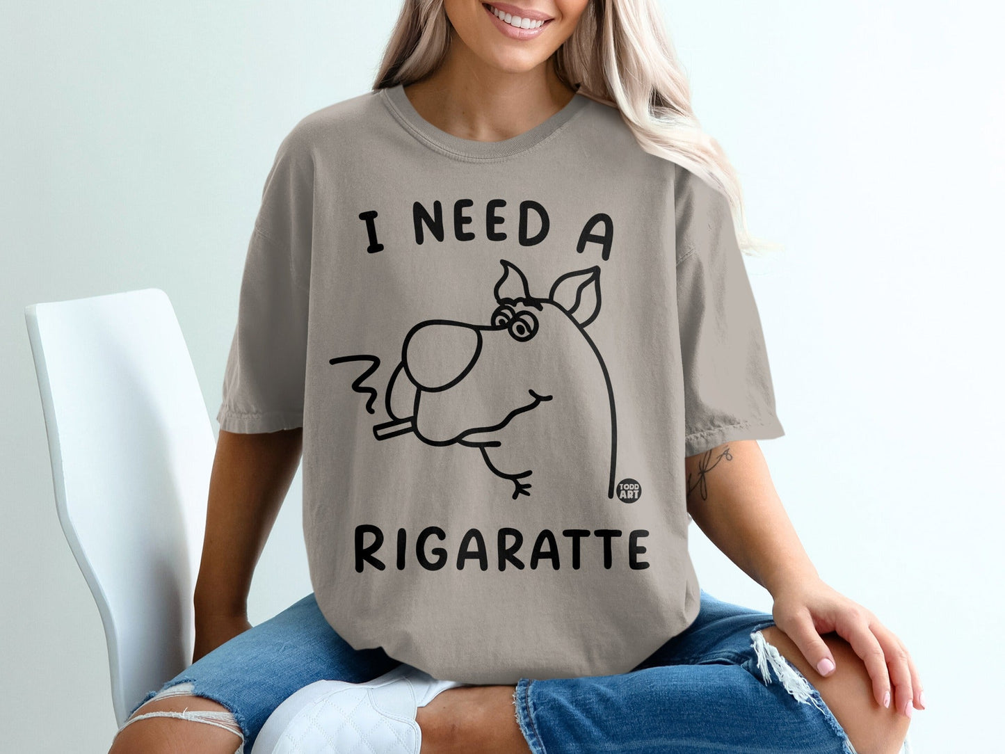 T-shirt with cartoon dog smoking and text "I NEED A RIGARETTE".