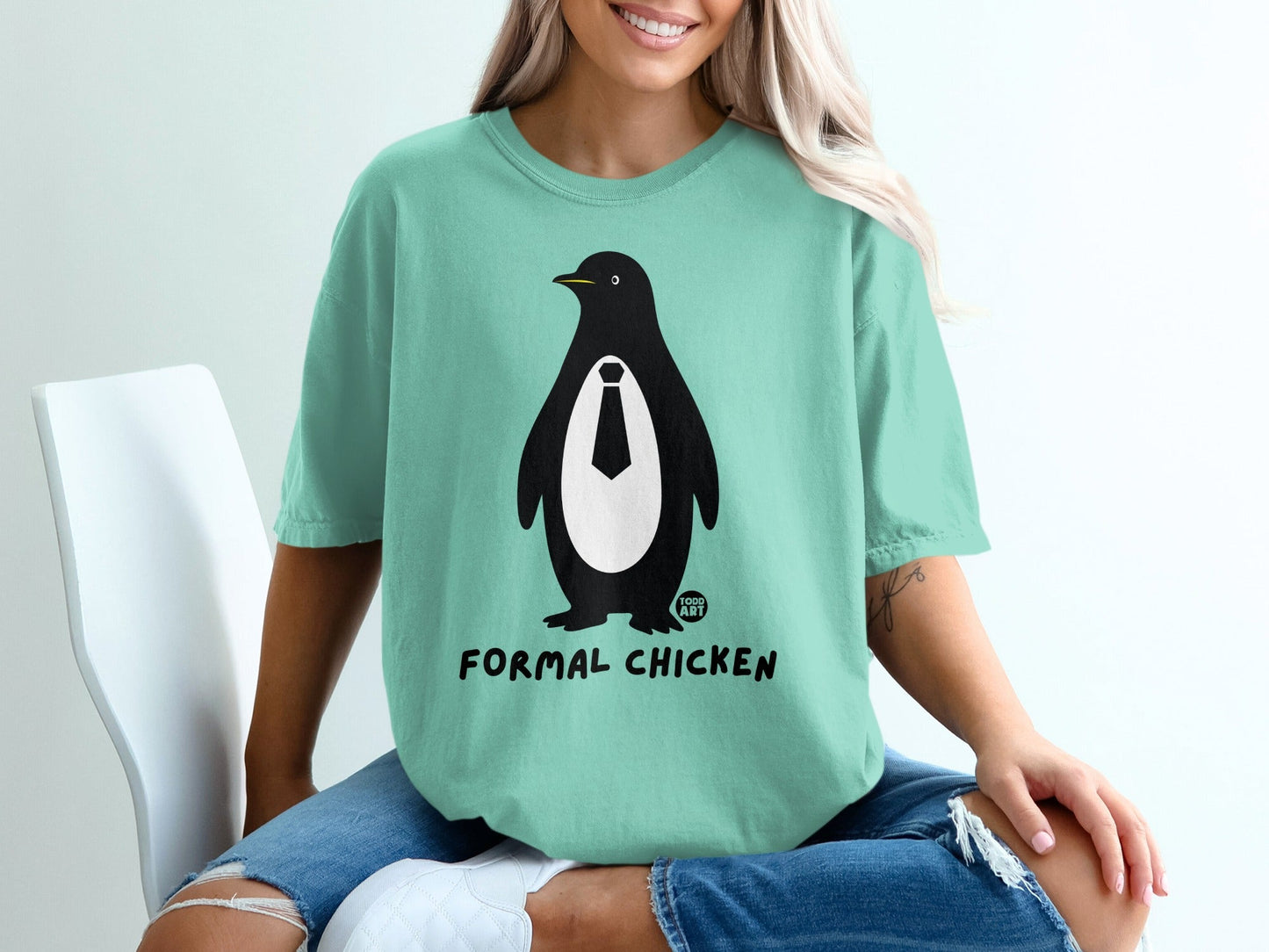 Mint green t-shirt with a penguin wearing a tie and text "FORMAL CHICKEN".