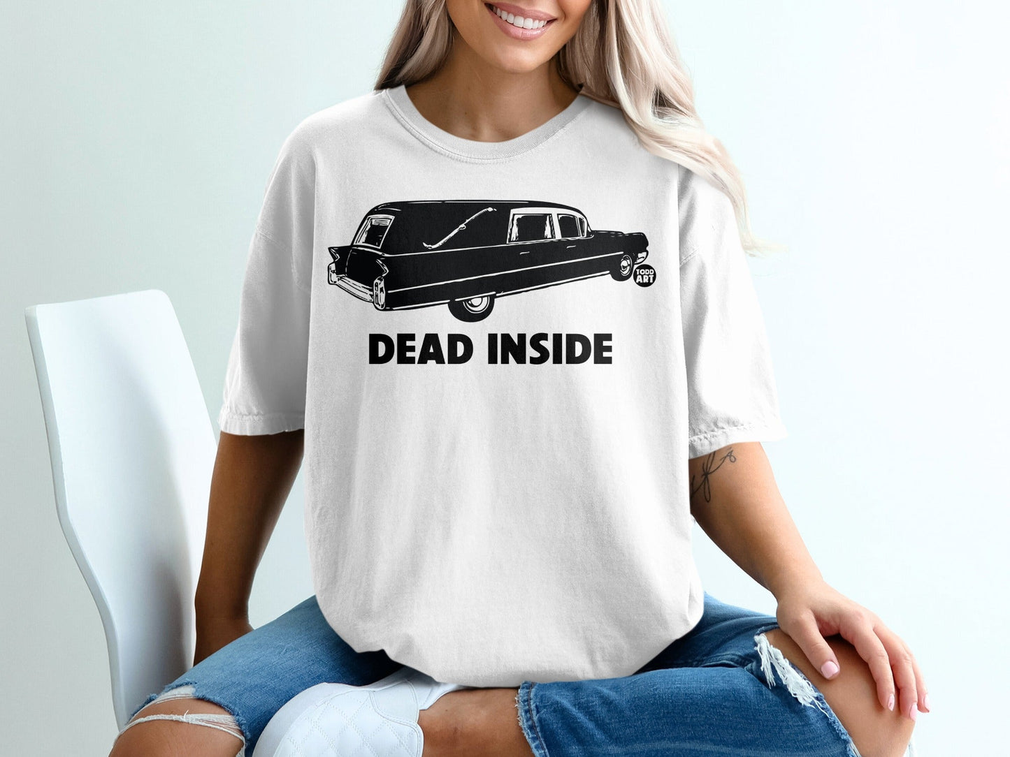 White t-shirt with a hearse graphic and "DEAD INSIDE" text.