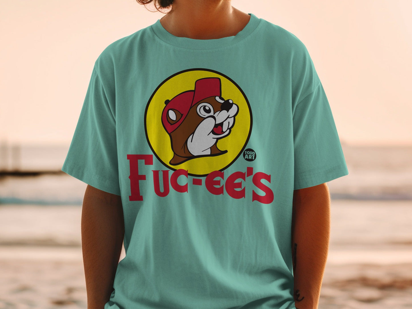 Teal t-shirt featuring Bucee's logo with beaver character and red cap.