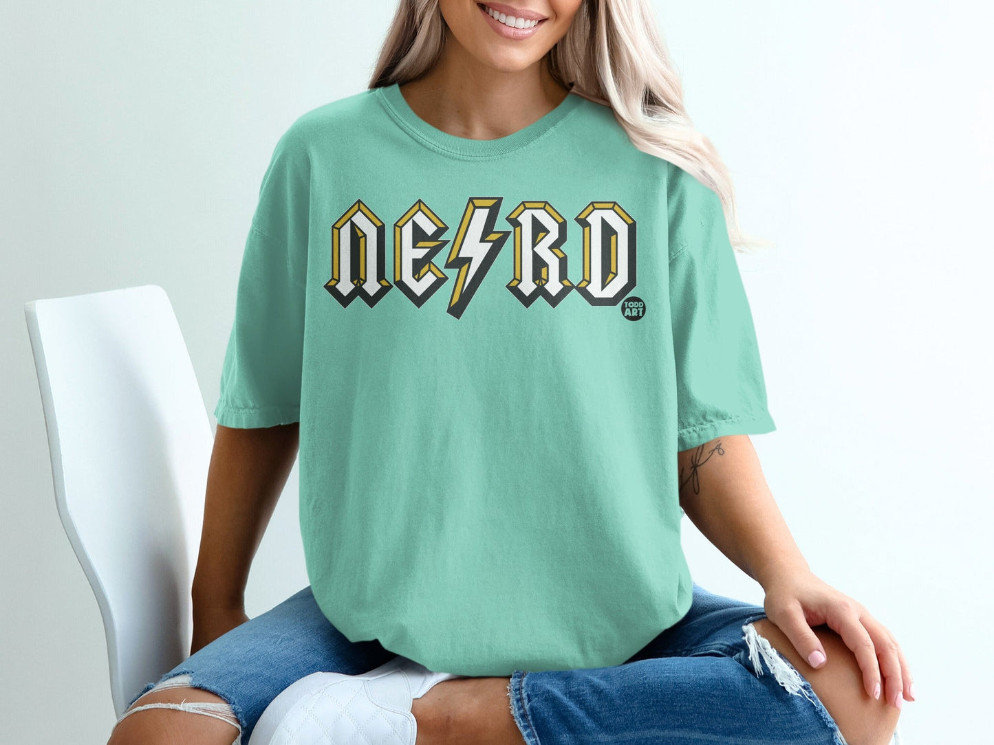 Teal t-shirt with "NERD" text in yellow and black lightning bolt design.