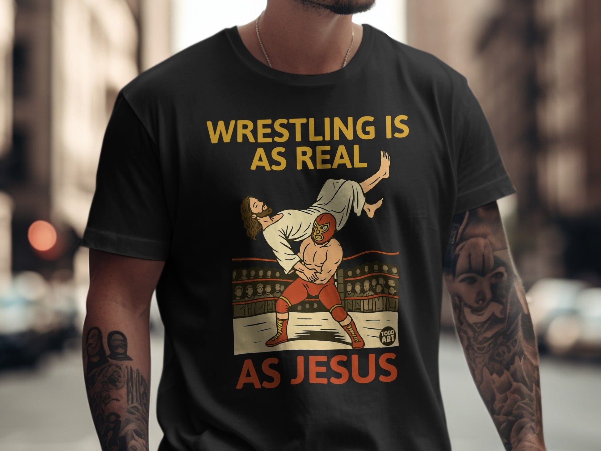 Wrestling is as real as Jesus graphic on a black t-shirt.