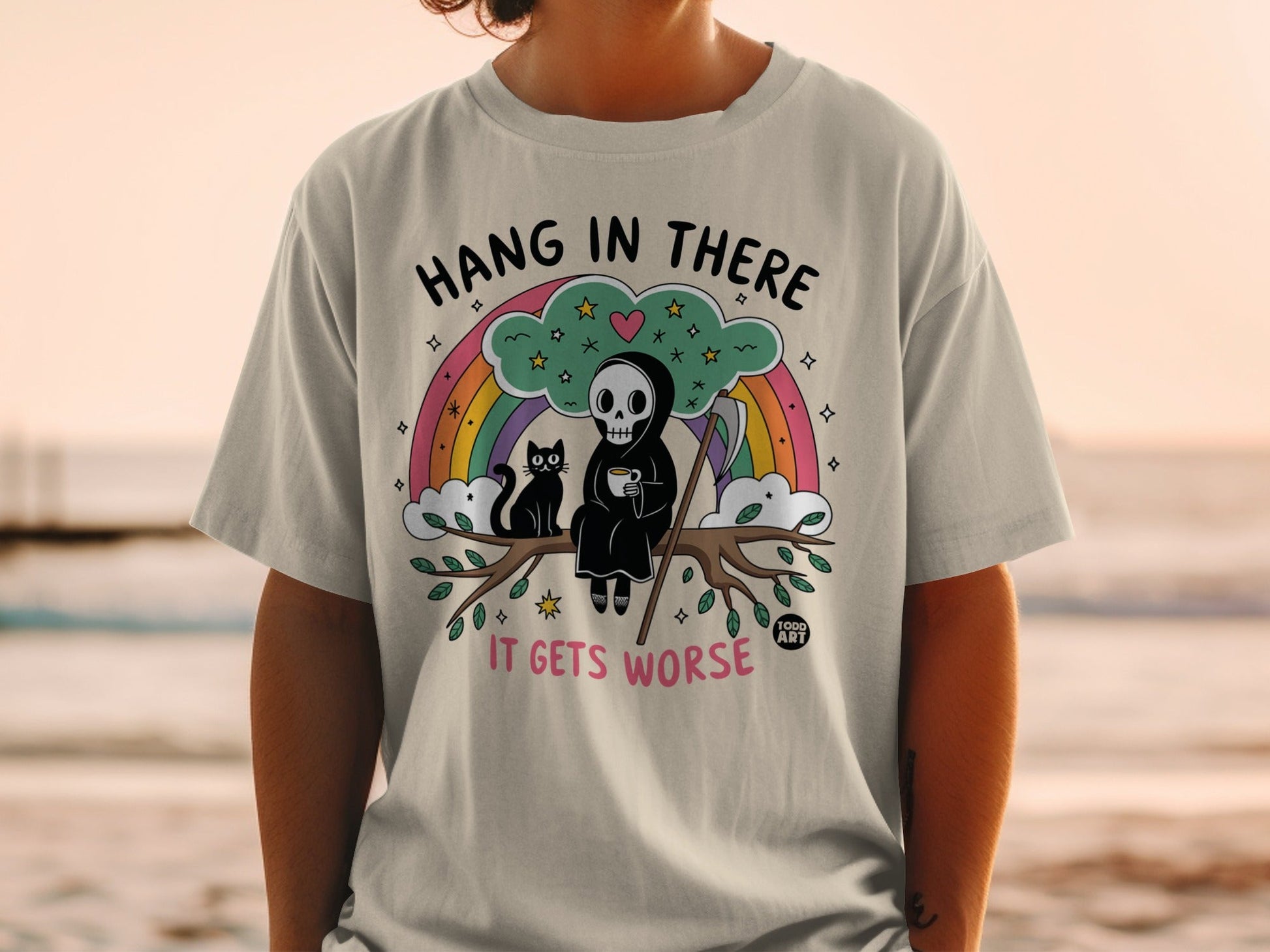 Grim reaper and cat hang in tree, "Hang in there it gets worse" text.