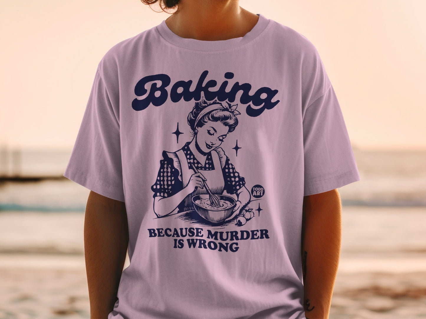 T-shirt with "Baking is wrong" text and retro illustration of woman baking.