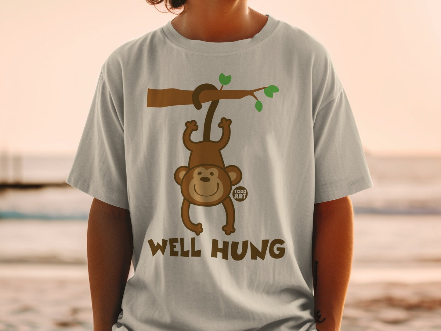 Cartoon monkey hanging from a tree branch with "WELL HUNG" text.