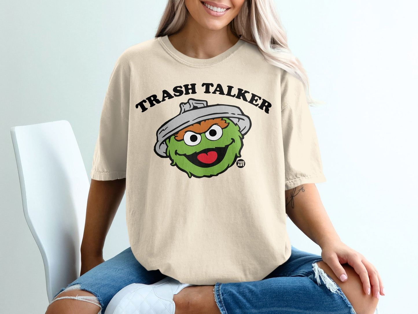 Oscar the Grouch "Trash Talker" graphic tee on a person.