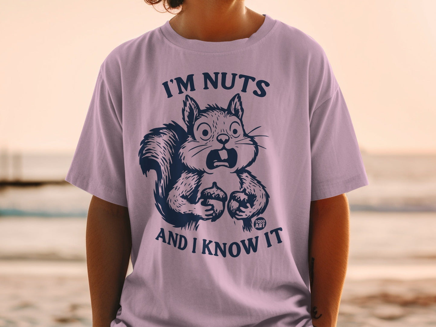 Purple t-shirt with shocked squirrel holding nut, text "I'M NUTS AND I KNOW IT".