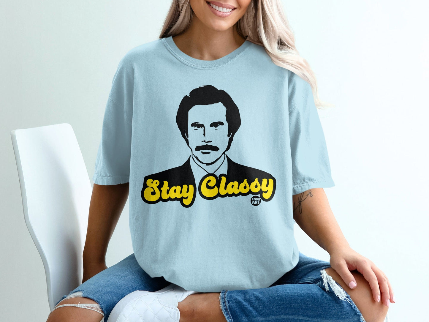 Light blue t-shirt with "Stay Classy" and a man's portrait.