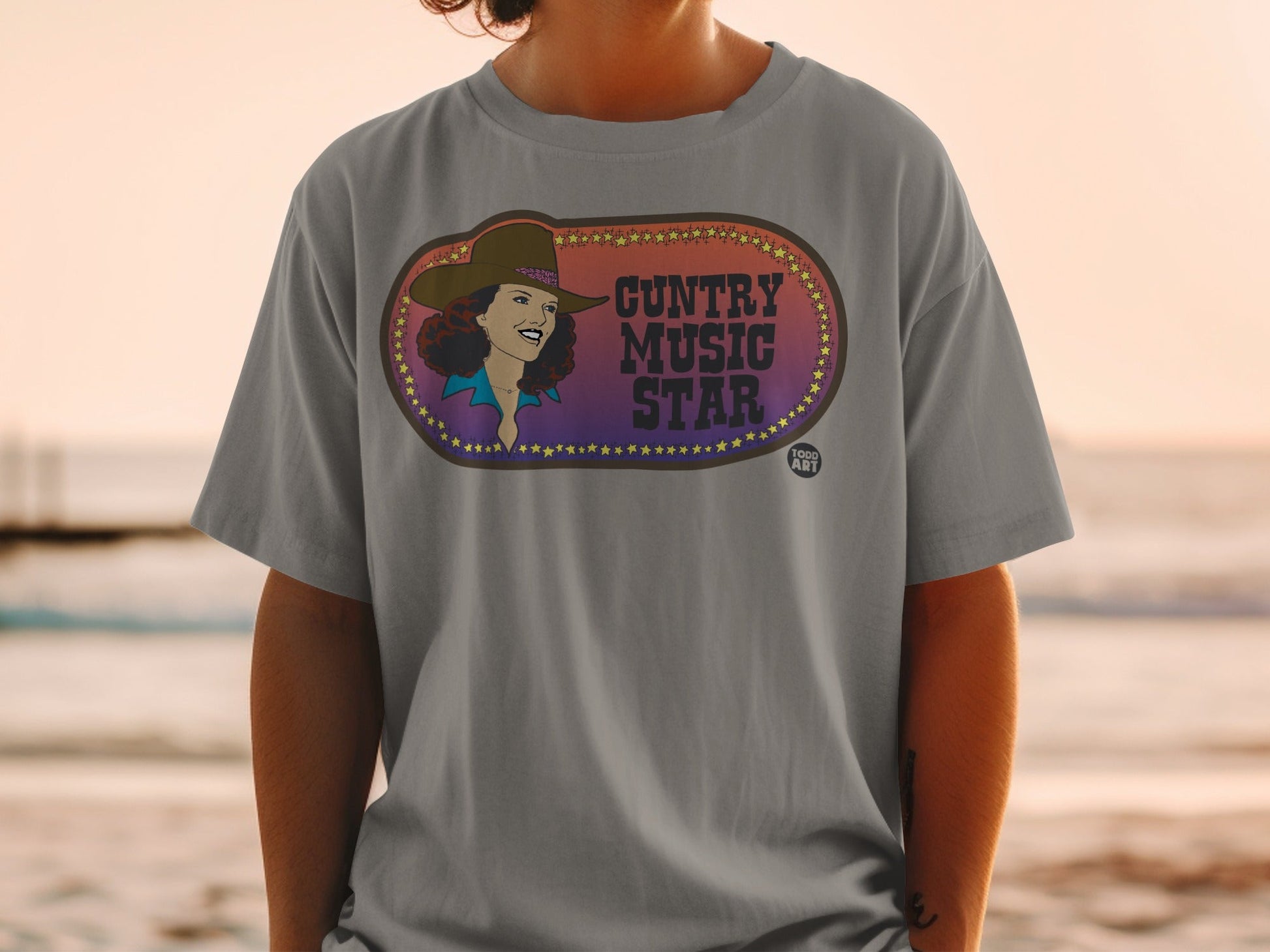 Grey t-shirt with "Country Music Star" text and vintage woman illustration.