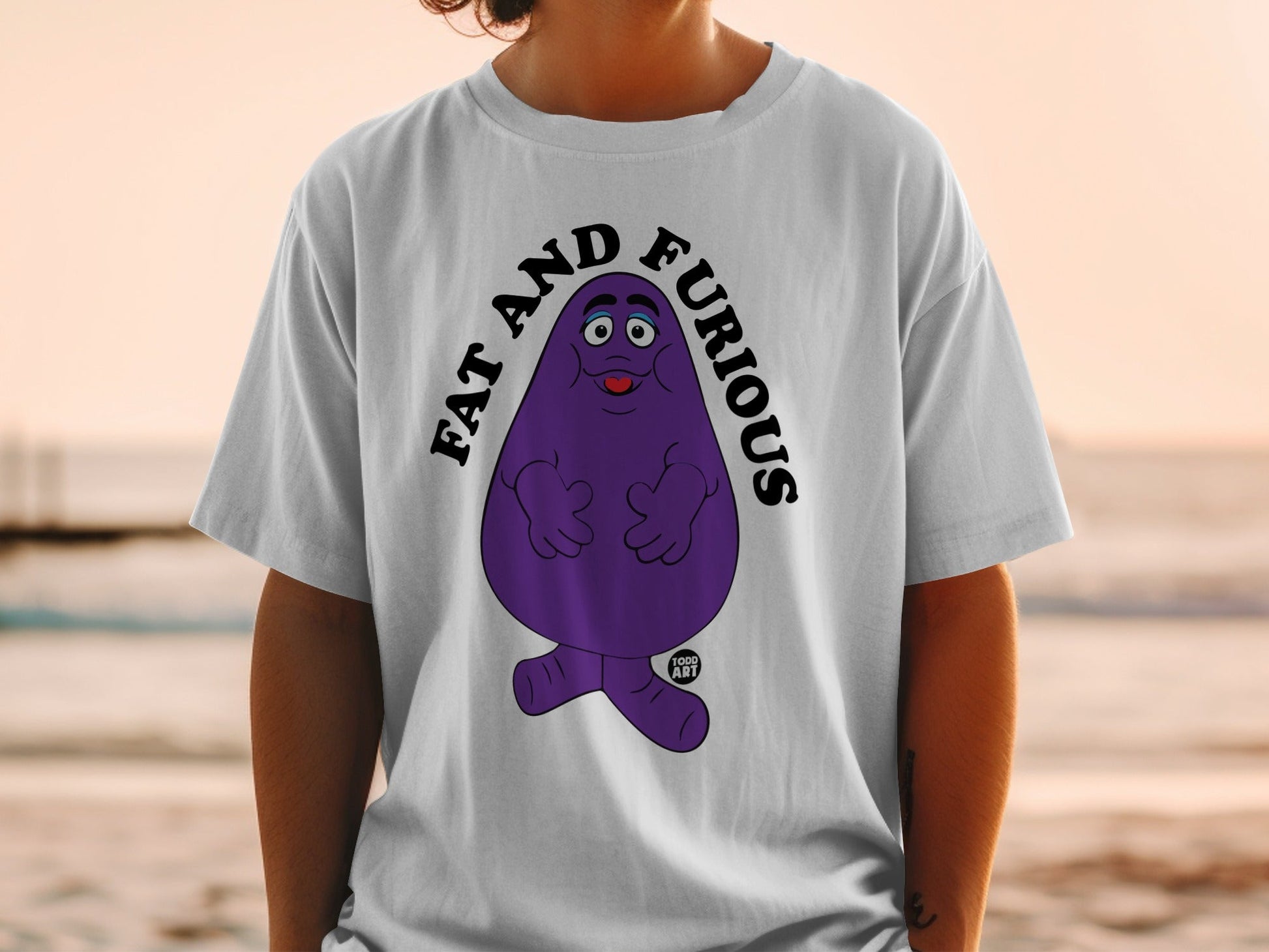 Purple character with text "FAT AND FURIOUS" on a white t-shirt.