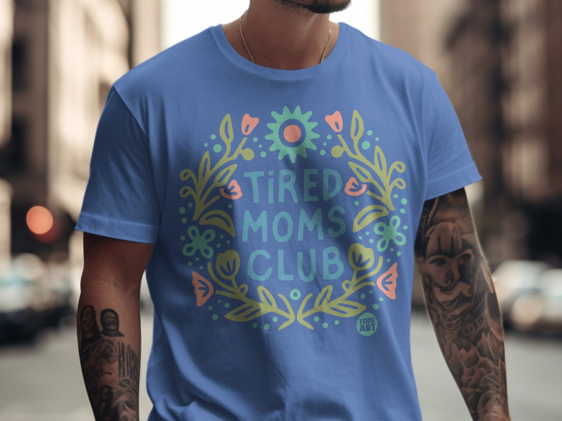 Blue t-shirt with "Tired Moms Club" in floral wreath.