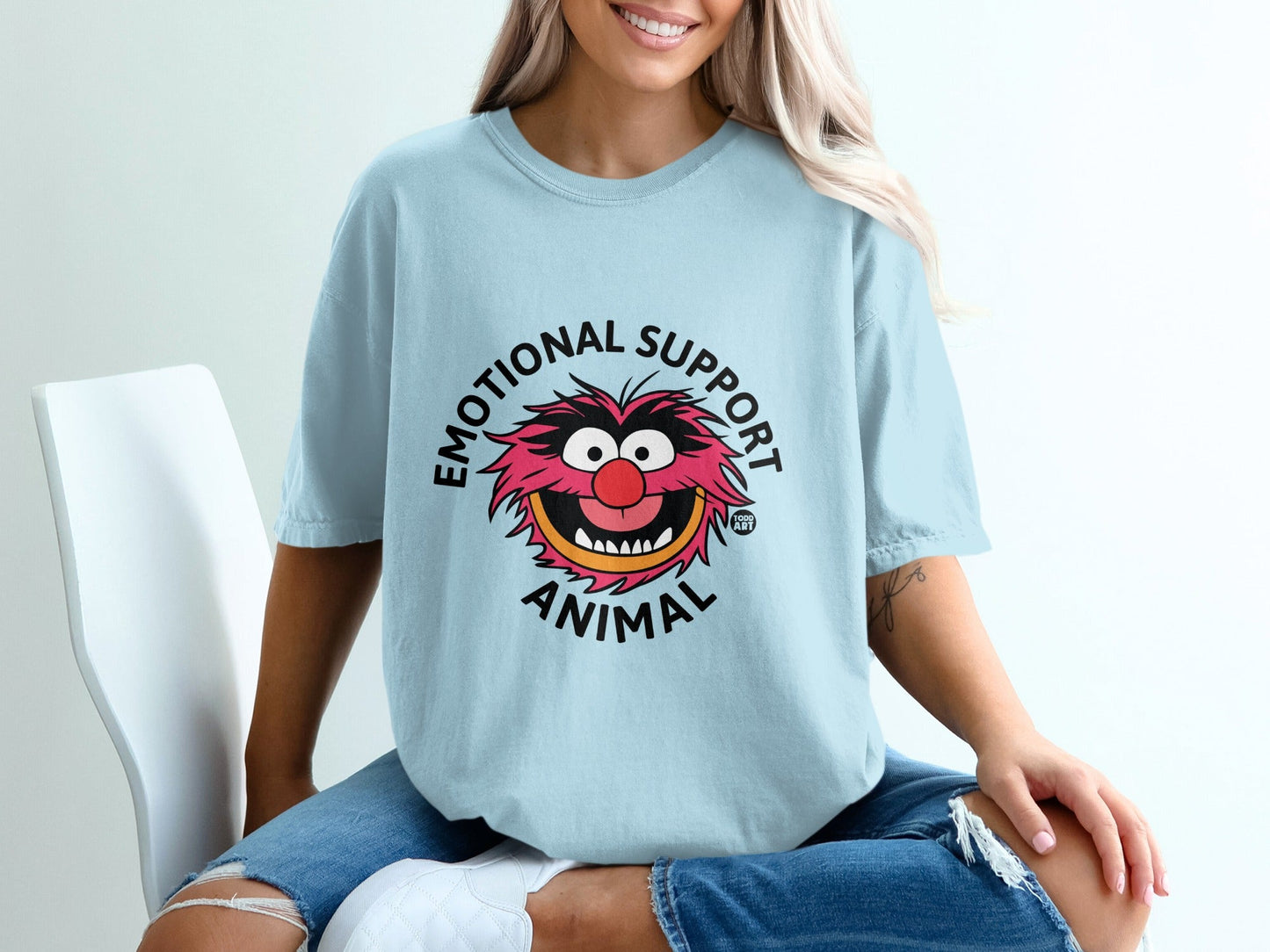 Light blue t-shirt with "Emotional Support Animal" text and Animal Muppet character.
