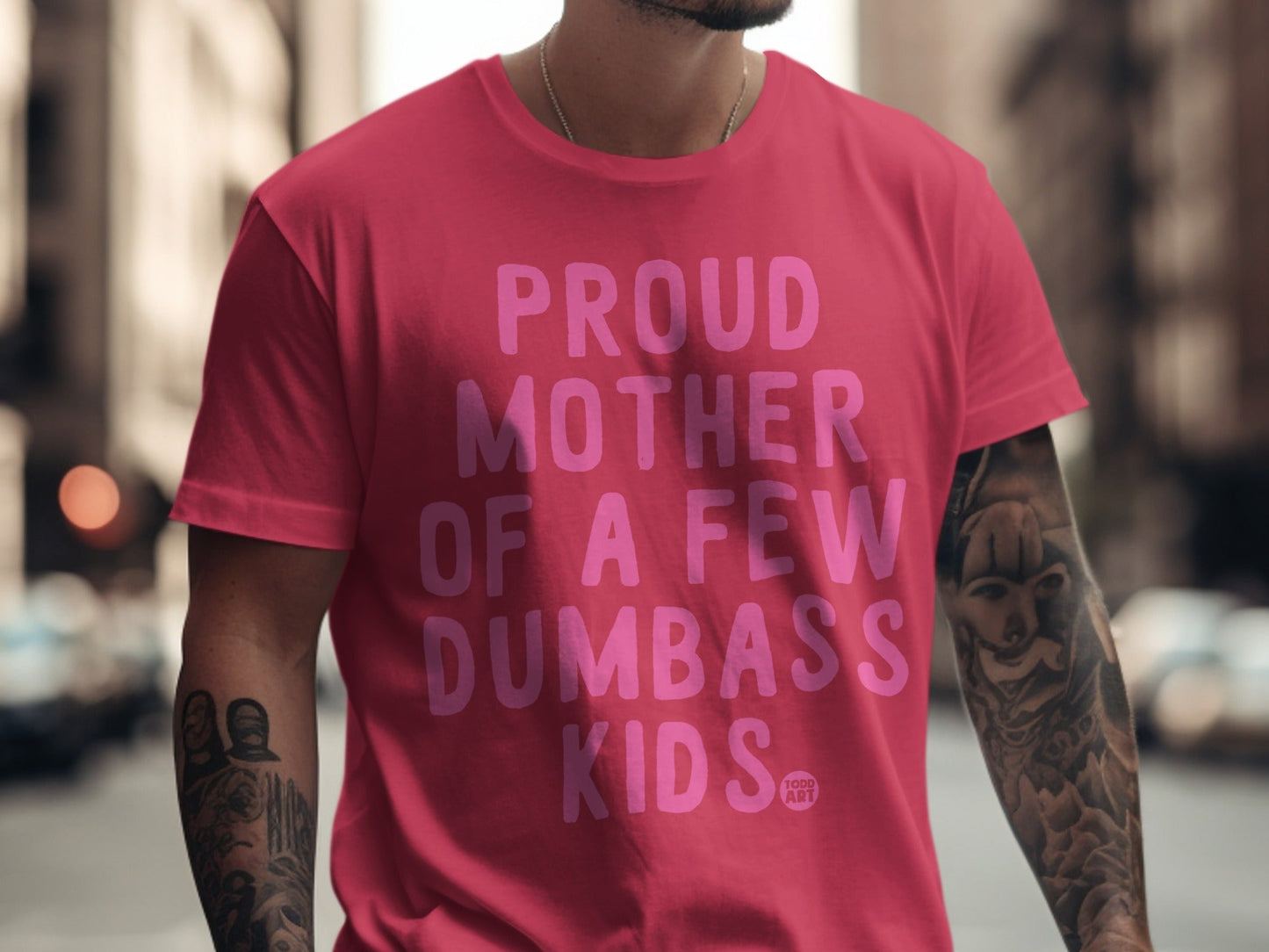 Pink t-shirt with "Proud Mother of a Few Dumbass Kids" text.